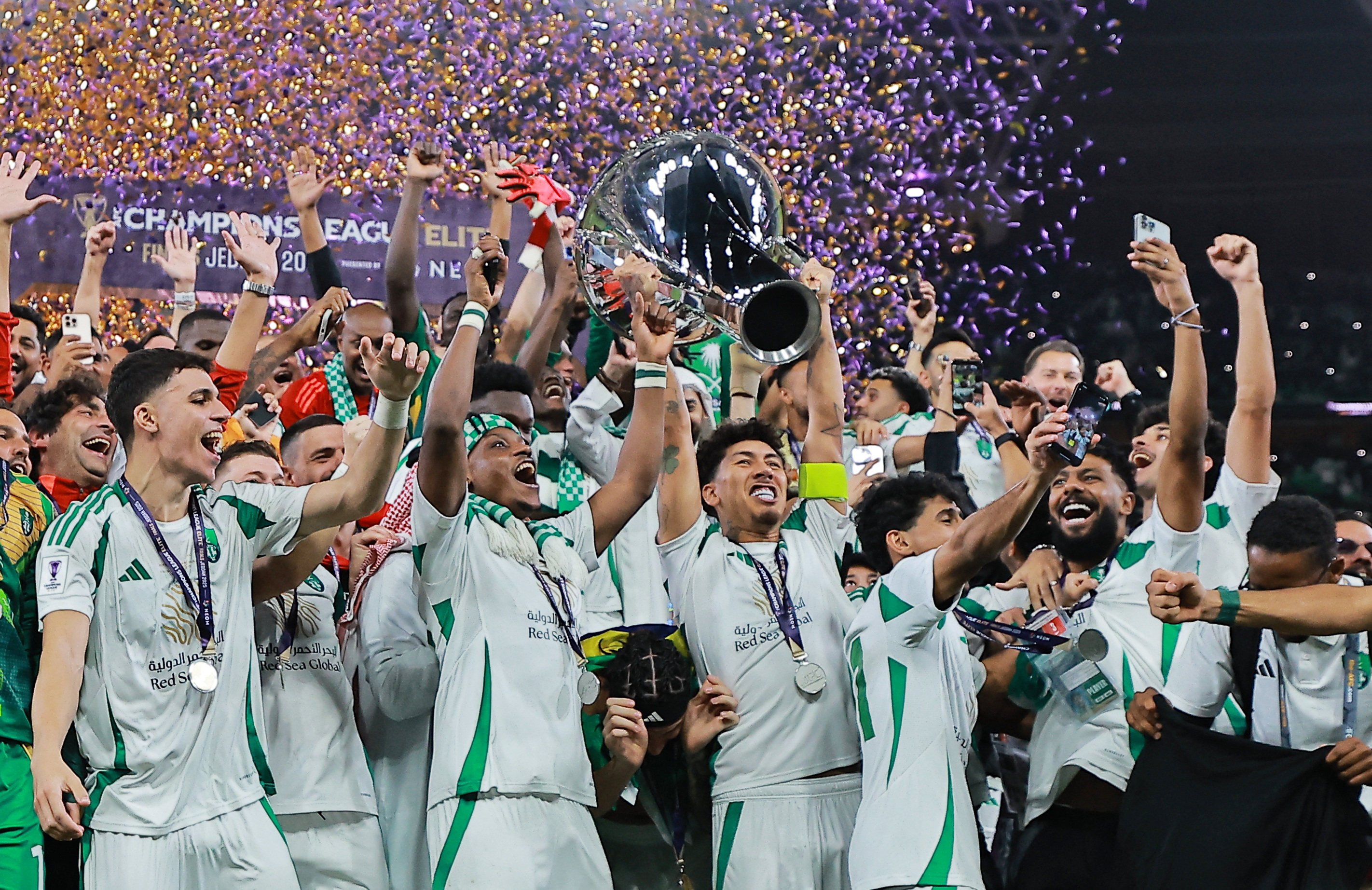 Al-Ahli’s Roberto Firmino lifts the trophy as he celebrates with teammates after winning the Asian Champions League. Photo: Reuters