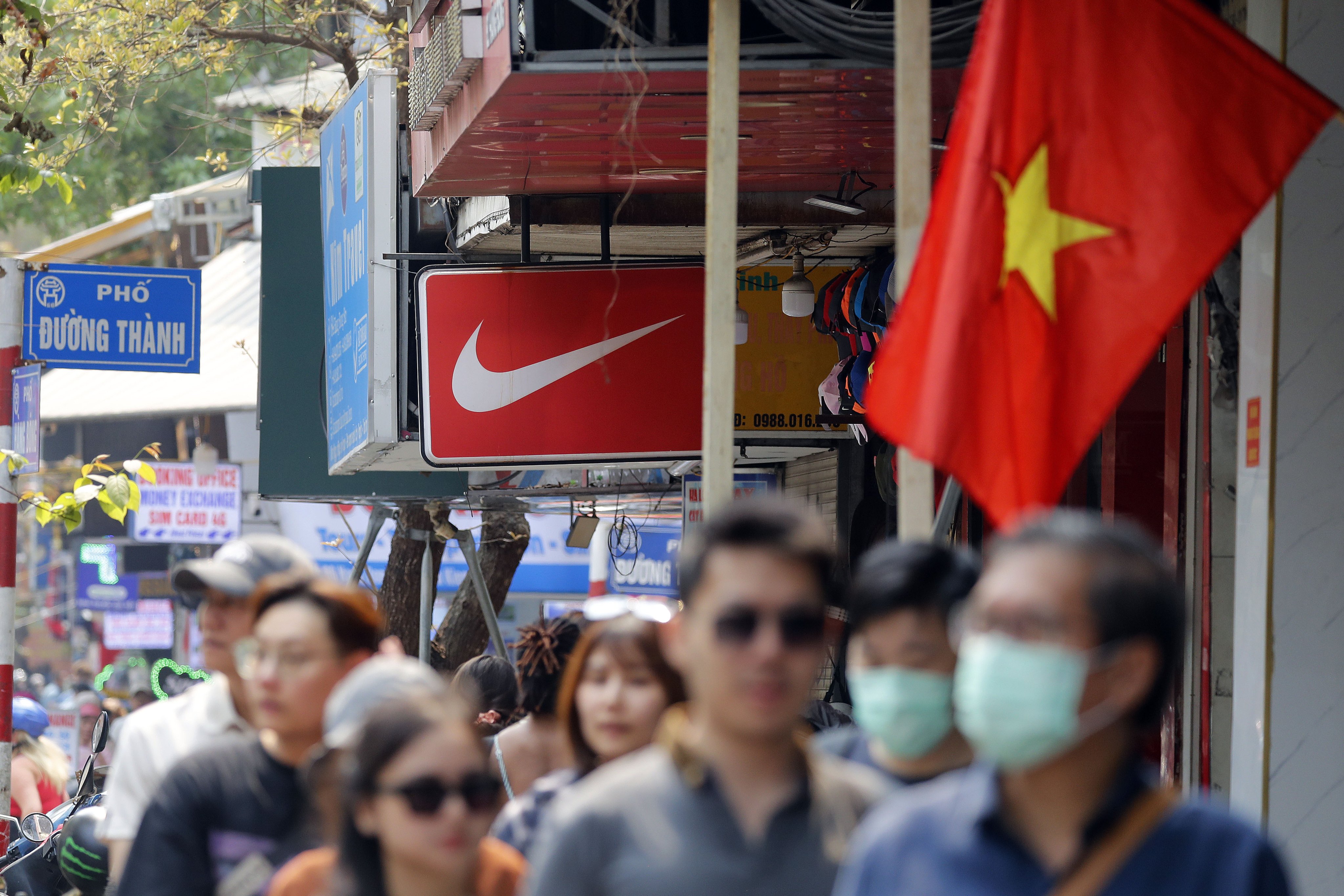 People walk past a Nike shop at a street in Hanoi, Vietnam on April 3. Photo: EPA-EFE