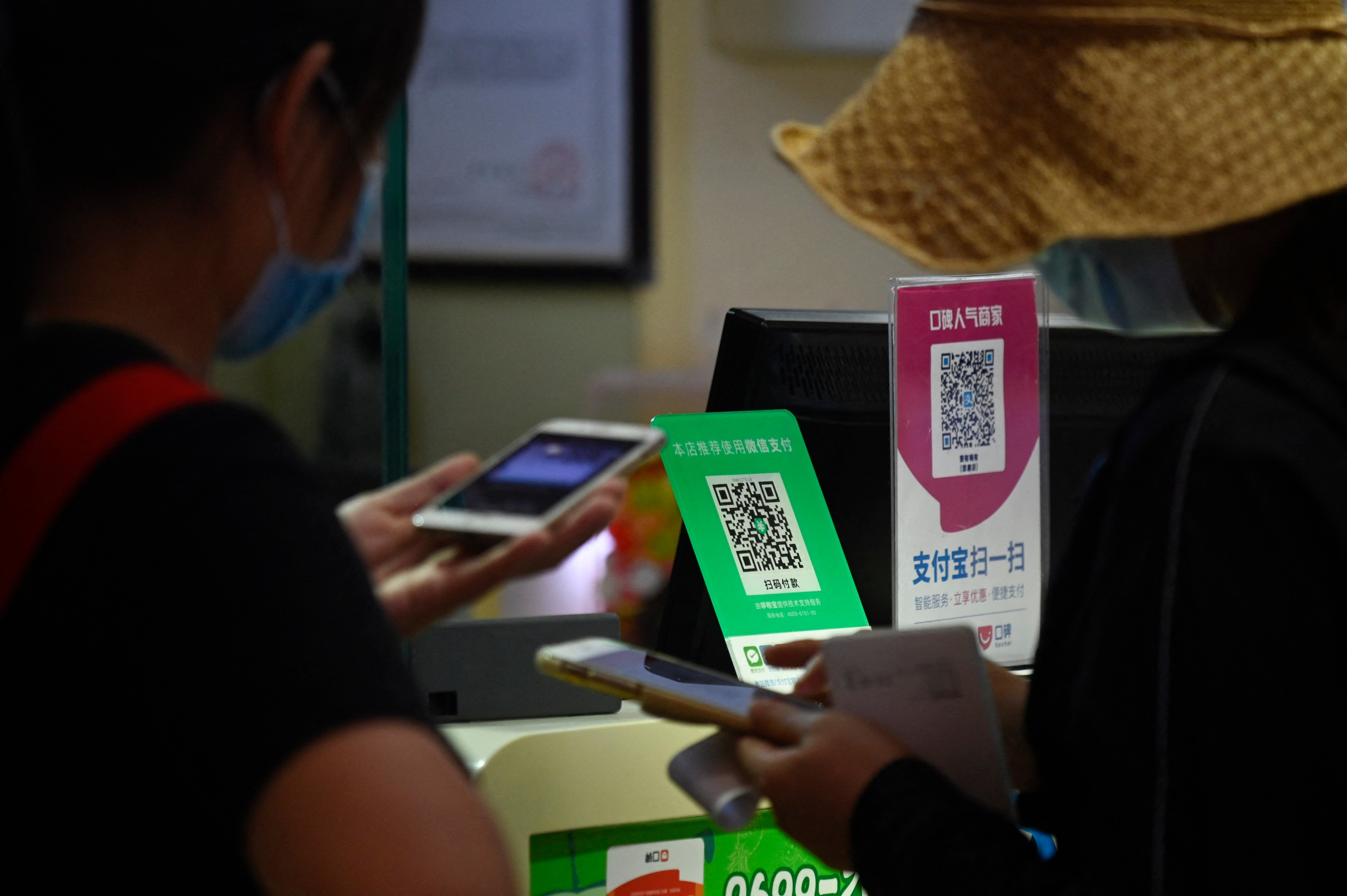 QR codes for WeChat Pay (left) and Alipay seen at a grocery store in Beijing on September 19, 2020. Photo: AFP