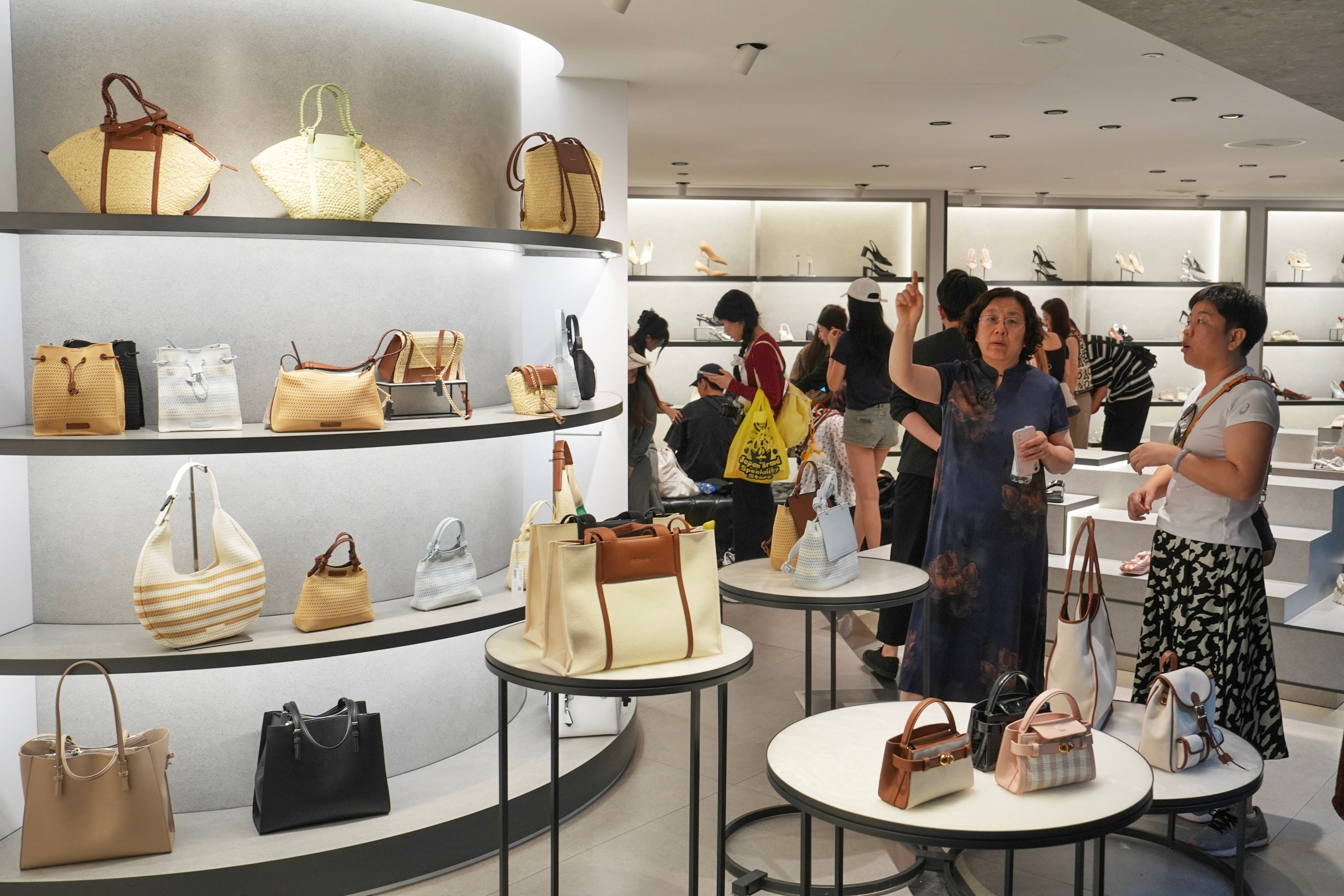 Customers browse handbags at a boutique store in Mong Kok. Photo: Elson Li