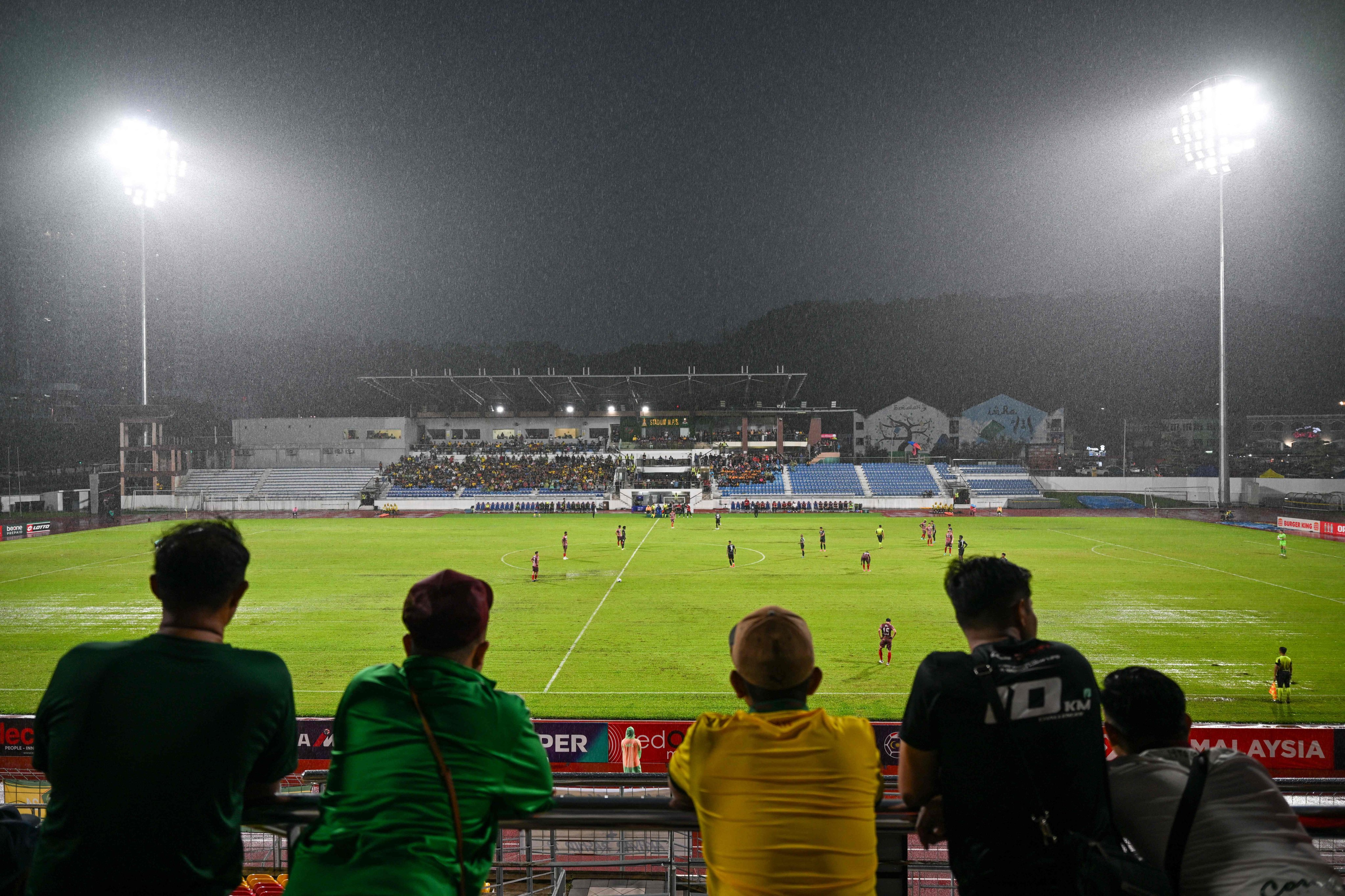 Fans watch the Malaysia Super League match between Kedah Darul Aman Football Club and Polis Di Raja Malaysia Football Club in Kuala Lumpur last May. Photo: AFP