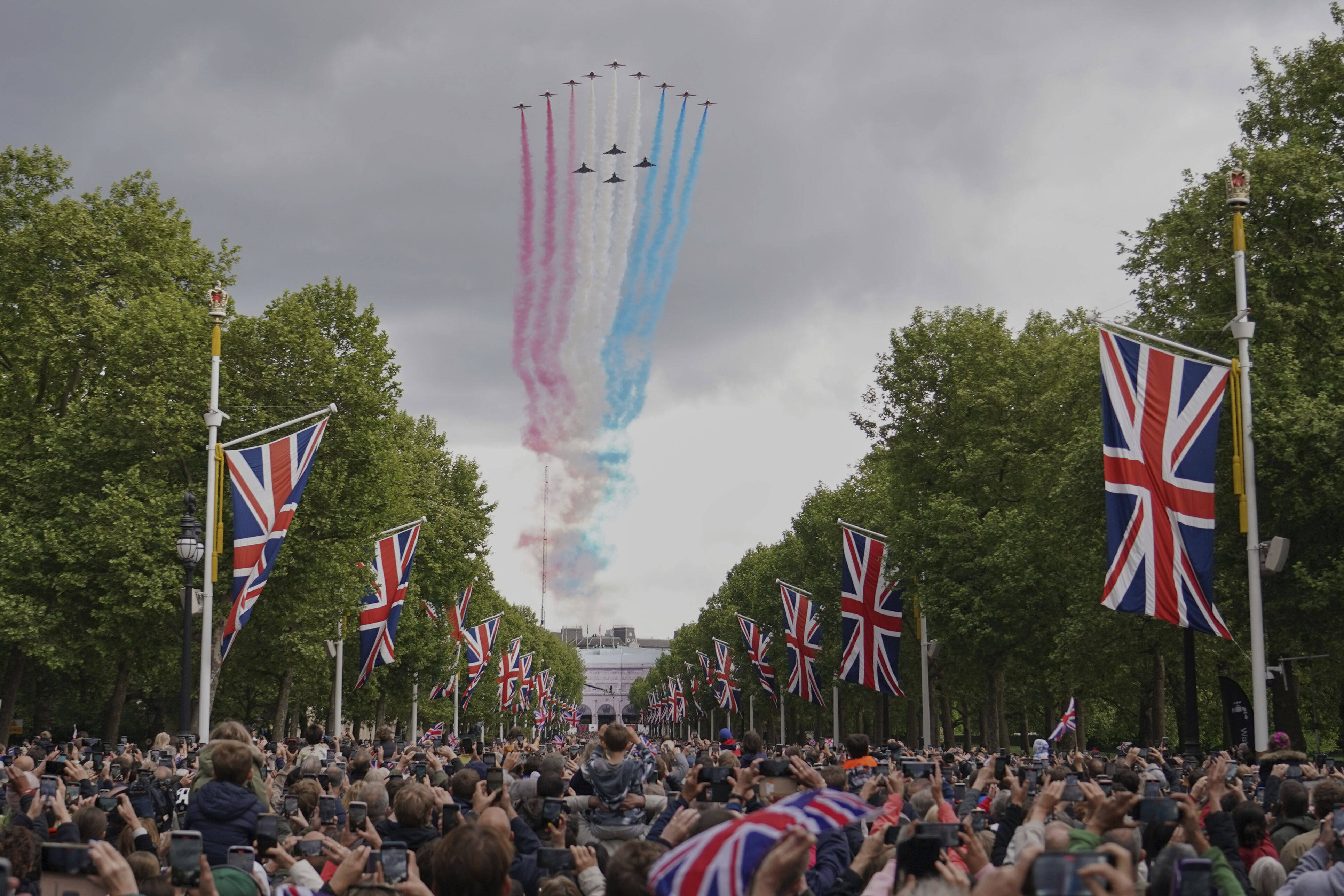 The Red Arrows the Royal Airforce display team, fly over the Mall and Buckingham Palace. Photo: AP