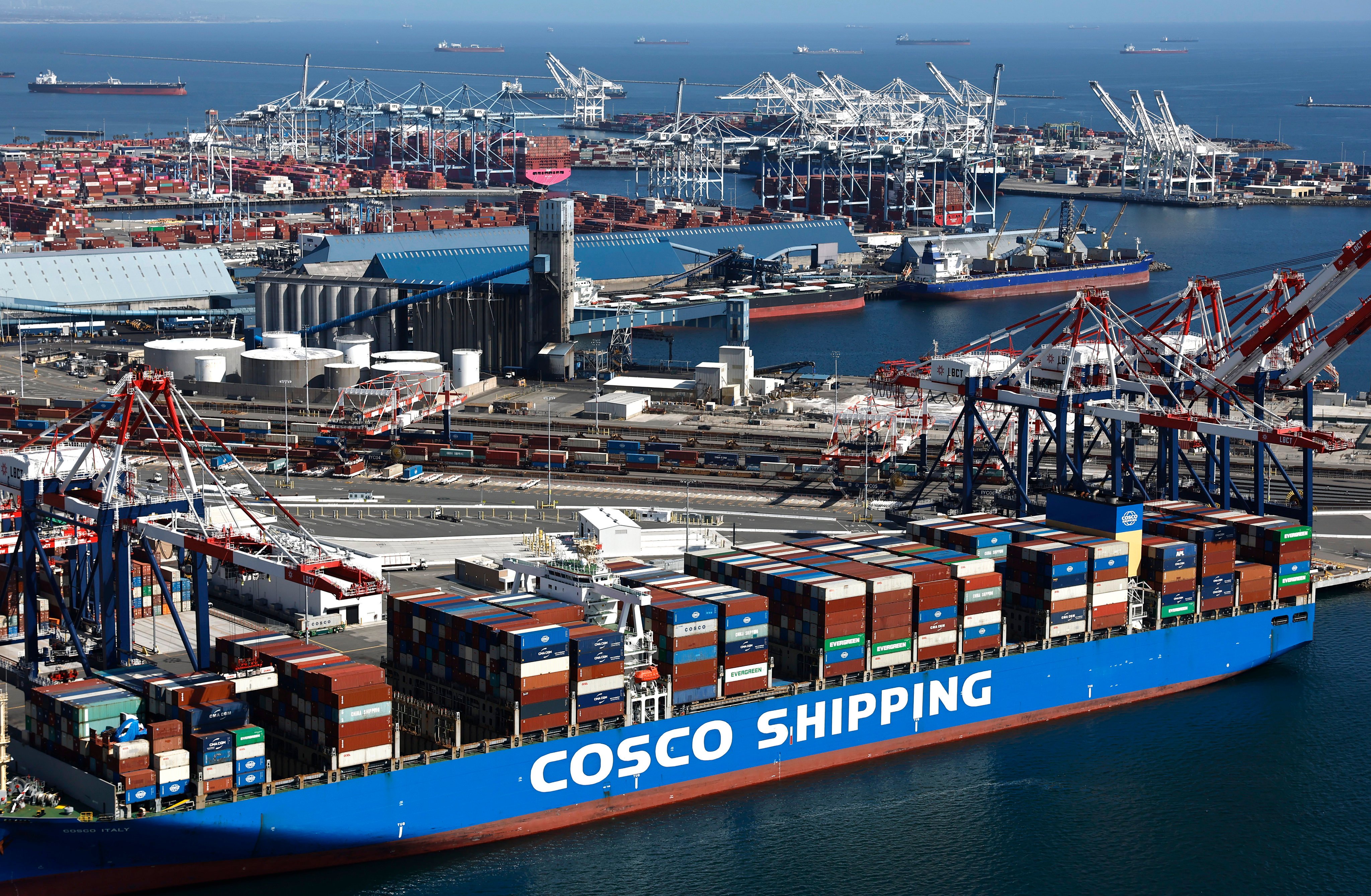 A Cosco Shipping container ship, China’s largest shipping line, is loaded with shipping containers in the Port of Long Beach. Photo: Getty
