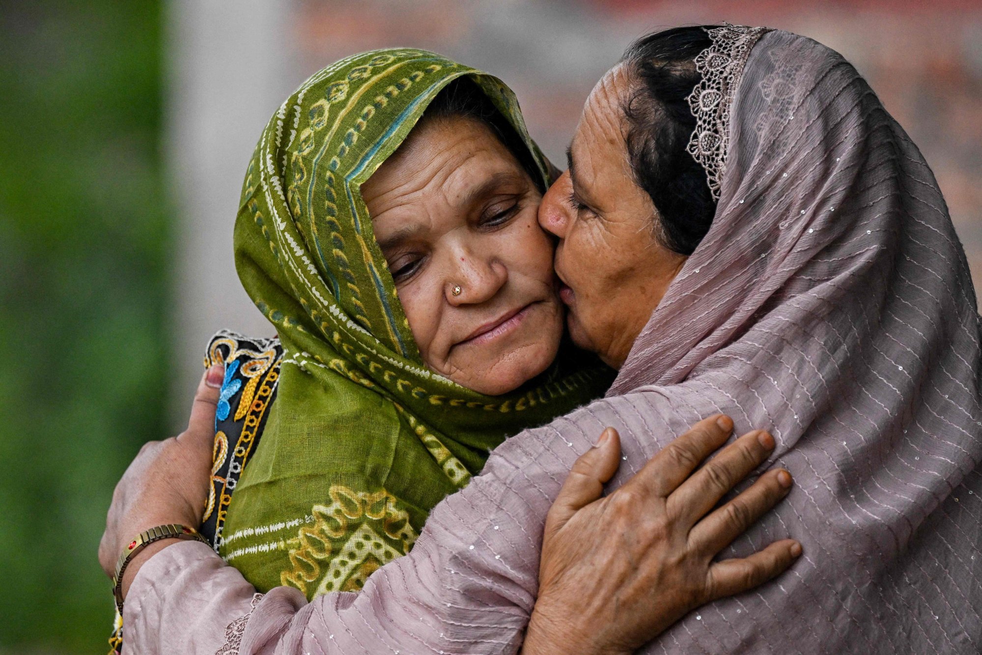 Nasreen Akhtar Bi (left) is embraced by her relative at her home in Salwah village near Mendhar, a militarised frontier region in Jammu. Photo: AFP Nasreen Akhtar Bi (left) is embraced by her relative at her home in Salwah village near Mendhar, a militarised frontier region in Jammu. Photo: AFP