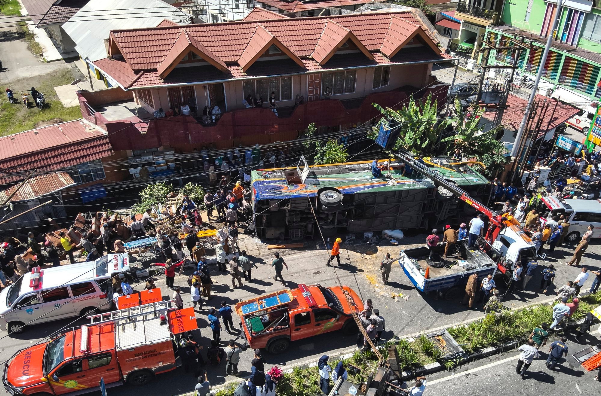 Rescuers working on an overturned bus after a crash in Indonesia on Tuesday. Photo: Indonesia’s Search and Rescue Agency/ EPA-EFE Rescuers working on an overturned bus after a crash in Indonesia on Tuesday. Photo: Indonesia’s Search and Rescue Agency/ EPA-EFE