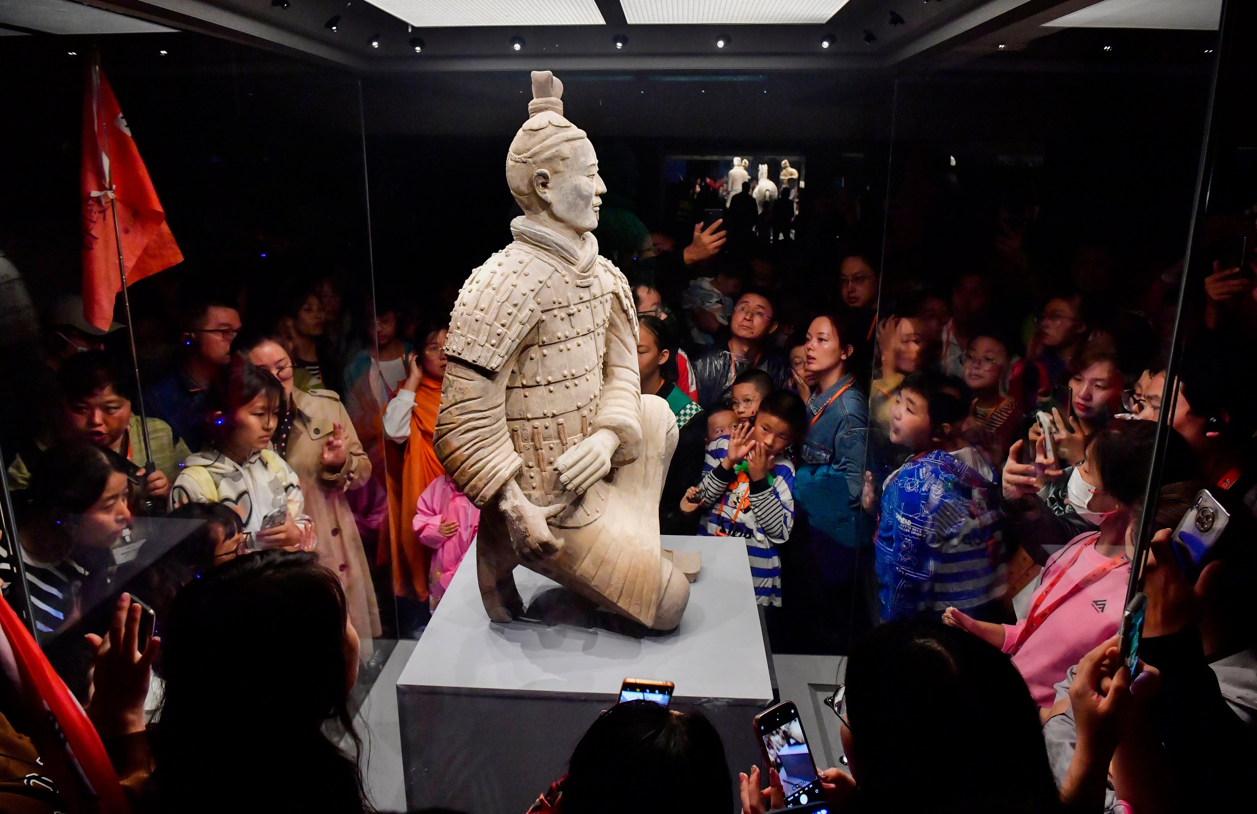 Tourists look at a Terracotta Army warrior in Xian, Shaanxi province, in 2023. In recent years, China has improved its system of museums and libraries while supporting a flourishing cultural industry. Photo: Xinhua