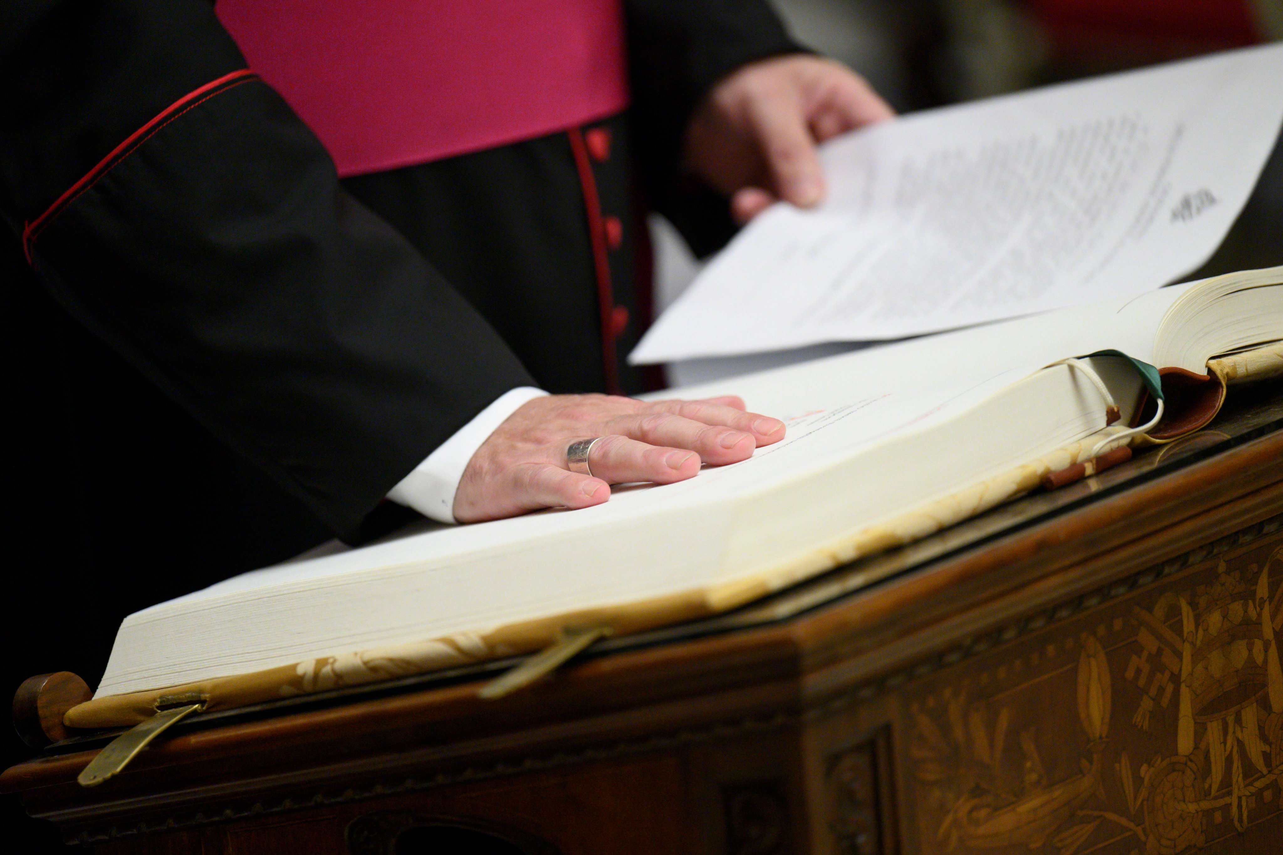 Vatican Master of Ceremonies Archbishop Diego Giovanni Ravelli takes the oath of secrecy for all those assigned to the conclave during a ceremony in the Pauline Chapel at the Vatican on Monday. Photo: Vatican Media/AP