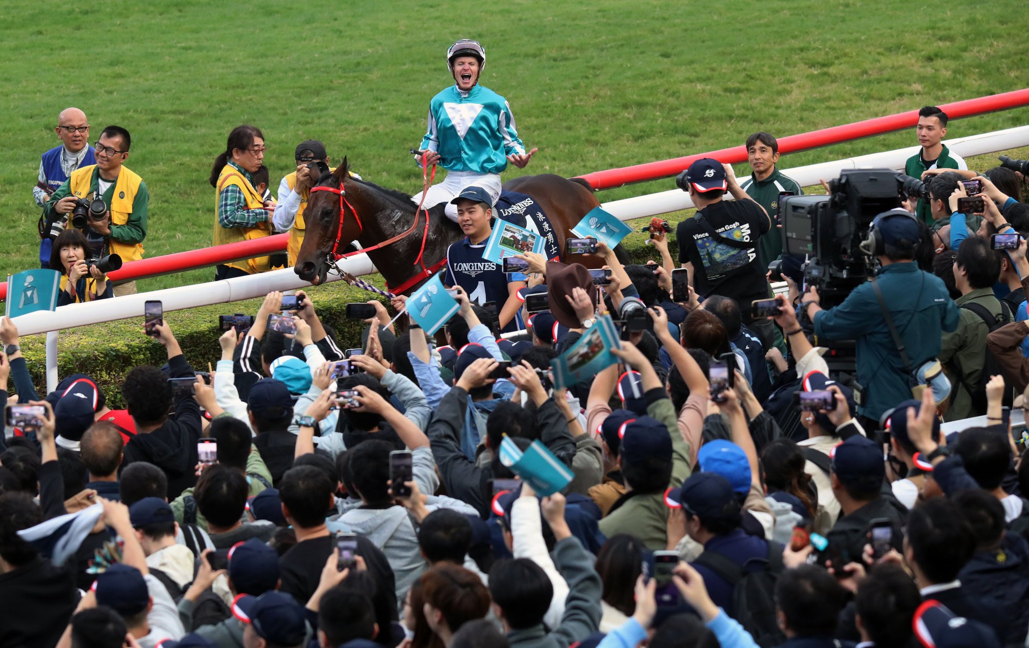 James McDonald celebrates with the crowd after Romantic Warrior’s third Hong Kong Cup victory in December.