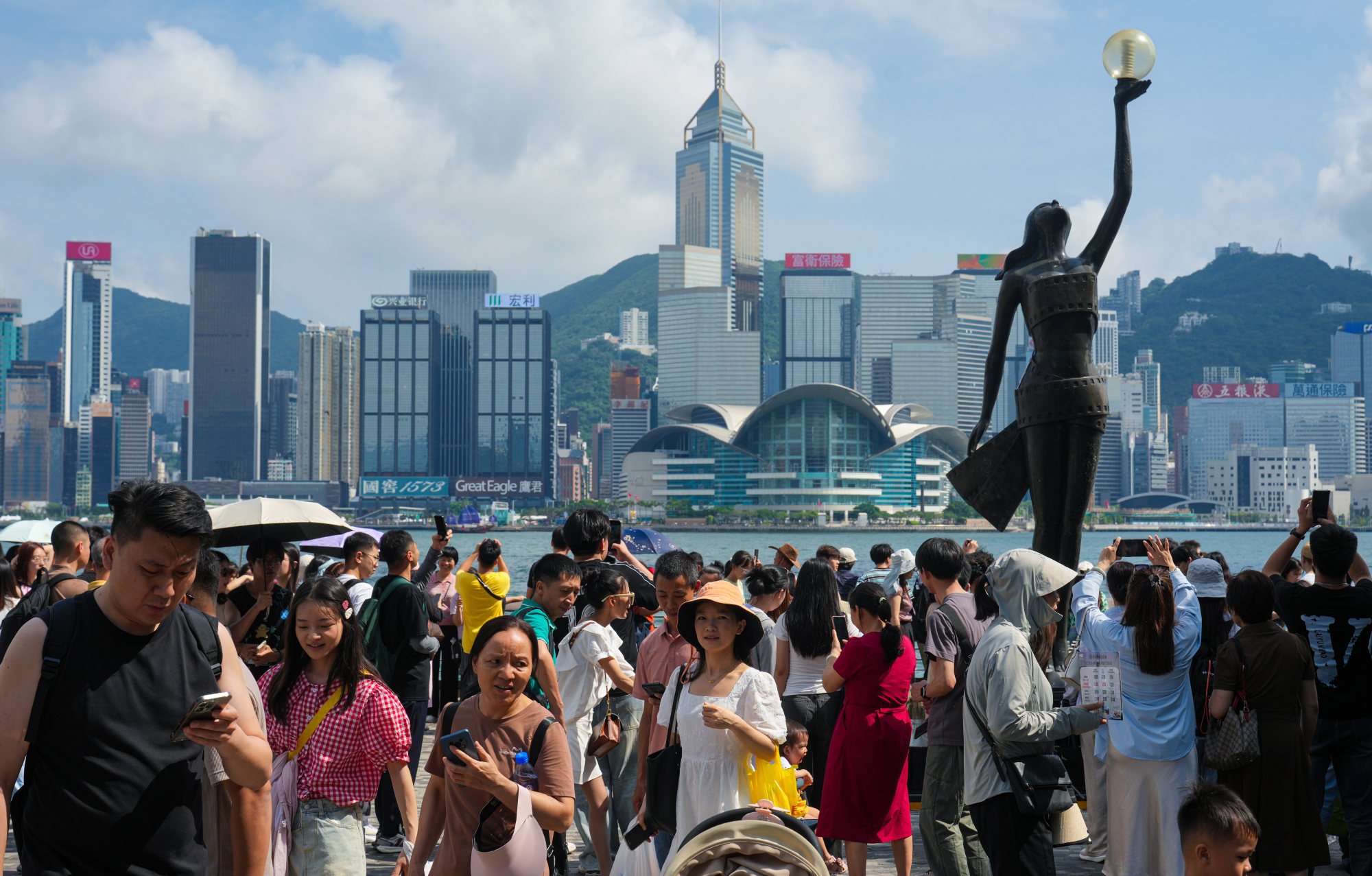 People gather along Victoria Harbour during the “golden week” holiday. Photo: Sam Tsang