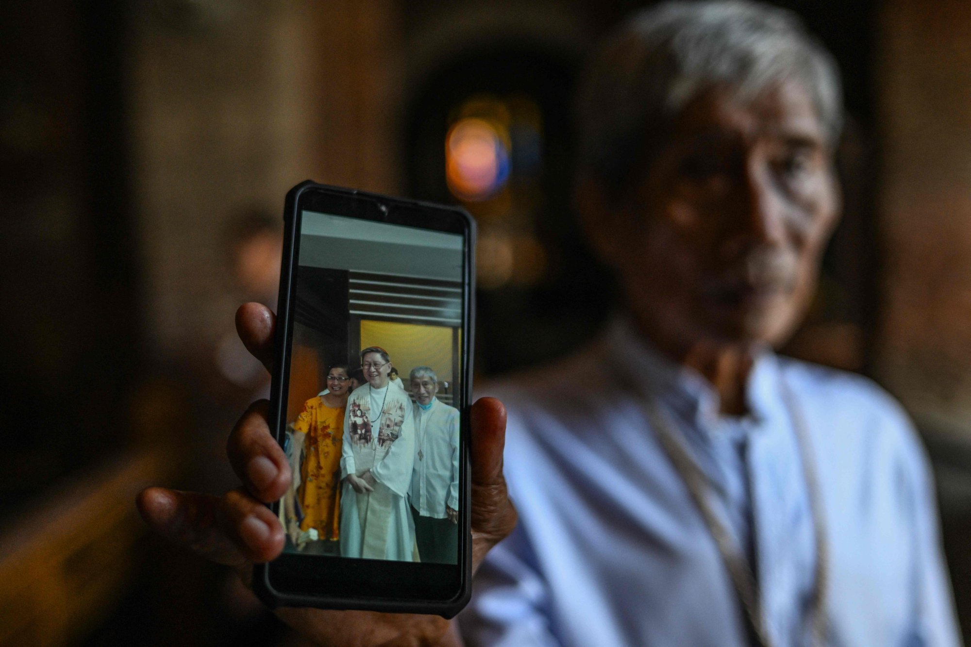 Francisco Abella Jnr shows a photo of himself and Cardinal Luis Antonio Tagle at the Imus Cathedral. Photo: AFP Francisco Abella Jnr shows a photo of himself and Cardinal Luis Antonio Tagle at the Imus Cathedral. Photo: AFP