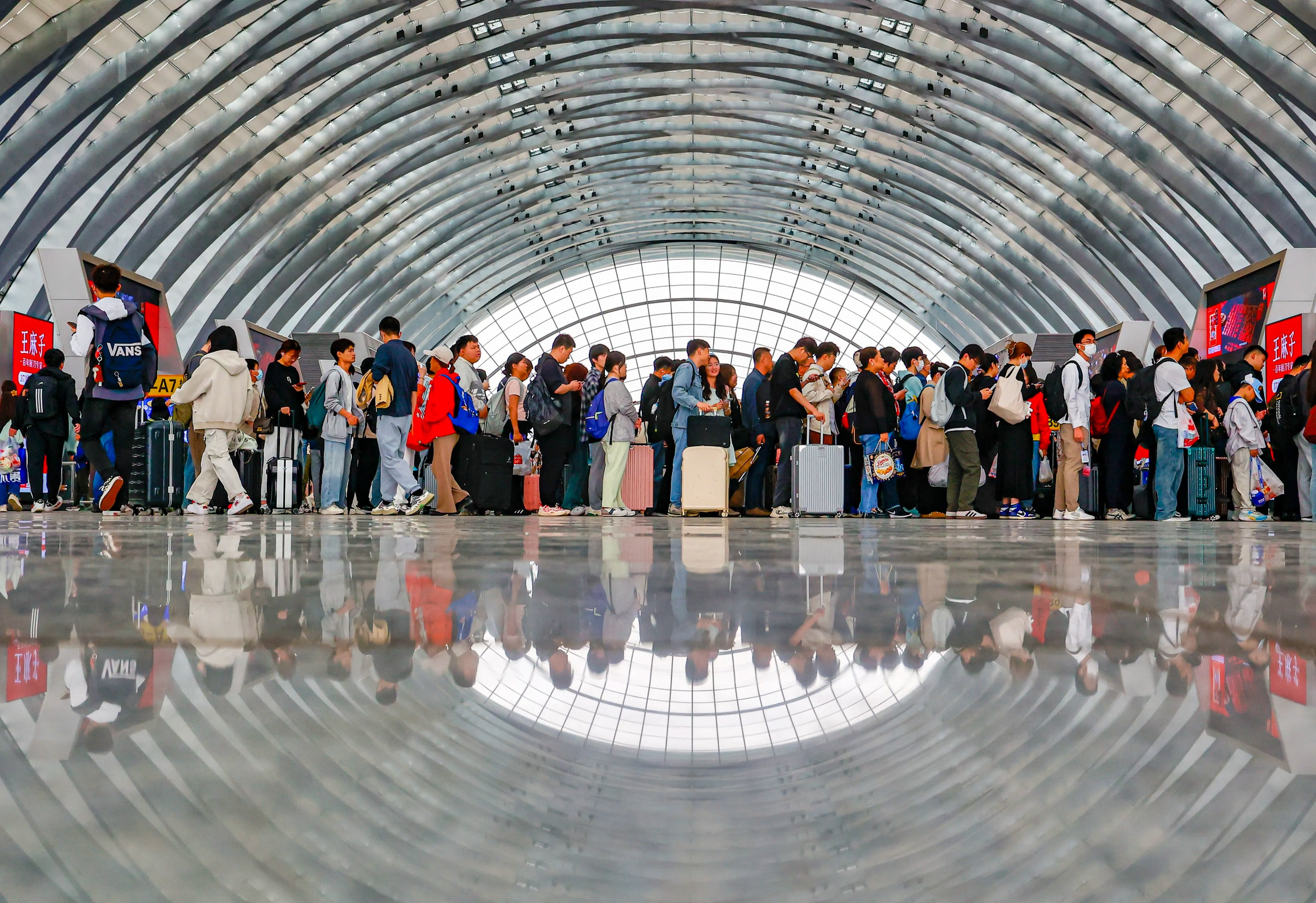 Passengers wait for trains at the Tianjin West Railway Station on Monday, the last day of the five-day Labour Day holiday period. China’s railway system transported more than 100 million passengers over the holiday. Photo: Xinhua