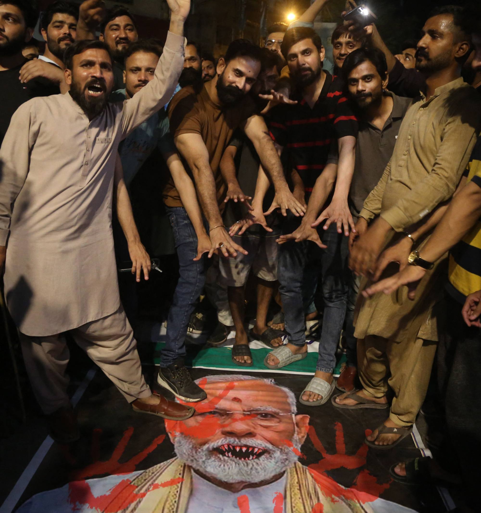Demonstrators shout slogans as they stand over a banner with a picture of India’s Prime Minister Narendra Modi during an anti-India protest in Hyberabad, India, on Wednesday. Photo: AFP Demonstrators shout slogans as they stand over a banner with a picture of India’s Prime Minister Narendra Modi during an anti-India protest in Hyberabad, India, on Wednesday. Photo: AFP