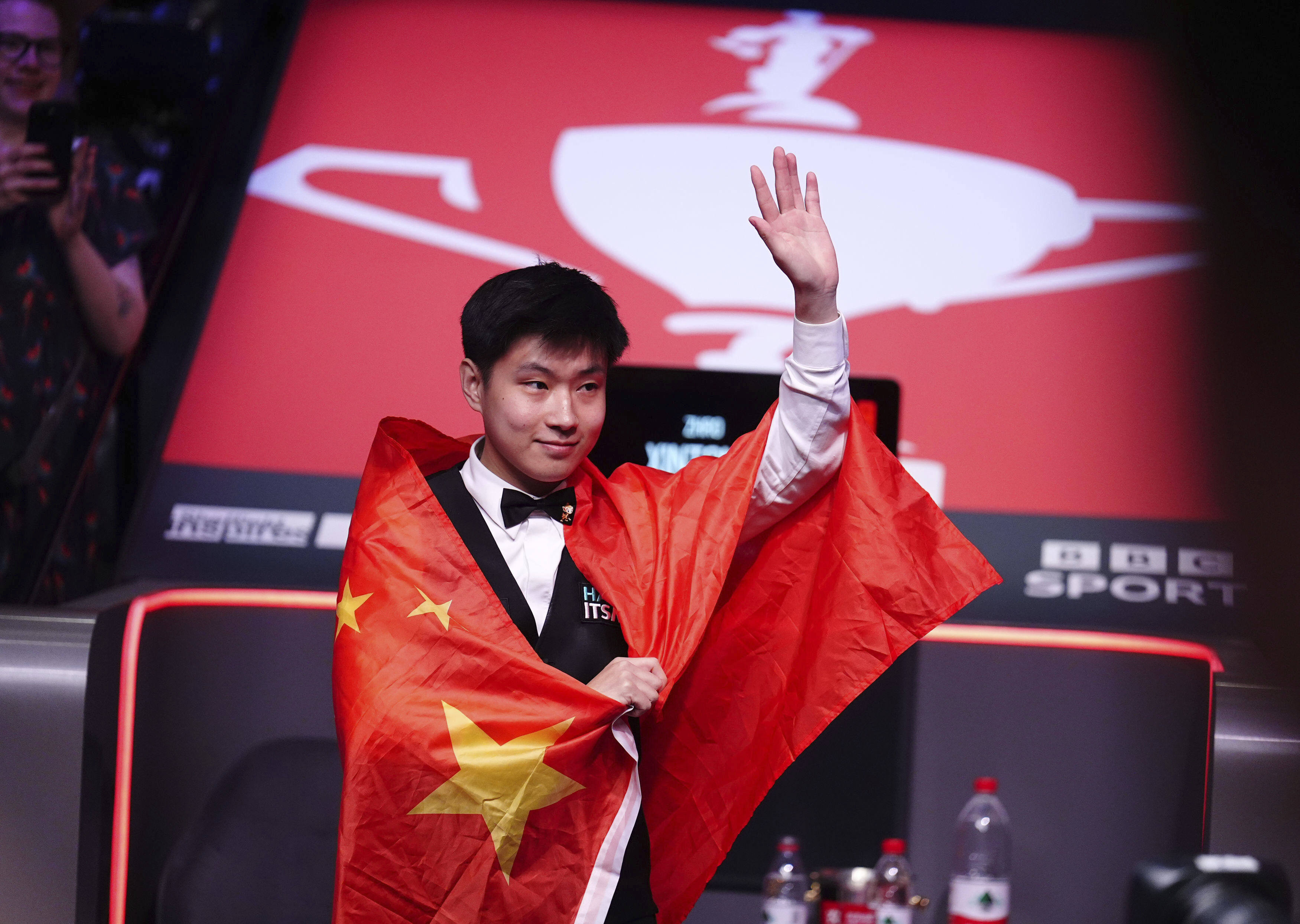 Zhao Xintong celebrates victory in the World Snooker Championship final in Sheffield on Monday. Photo: AP