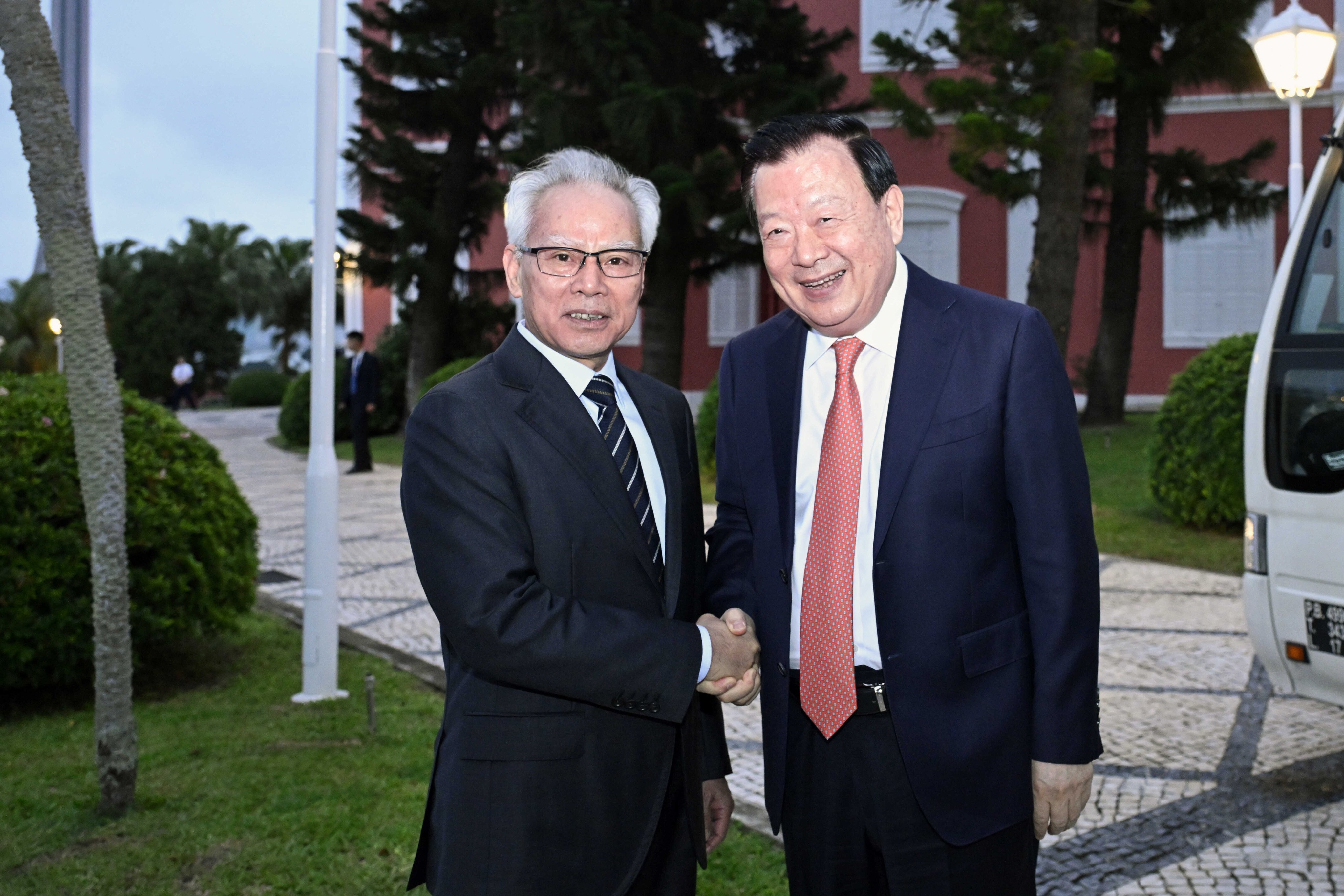 Chief Executive Sam Hou-fai (left) greets Xia Baolong at the start of his visit on Thursday. Photo: Handout