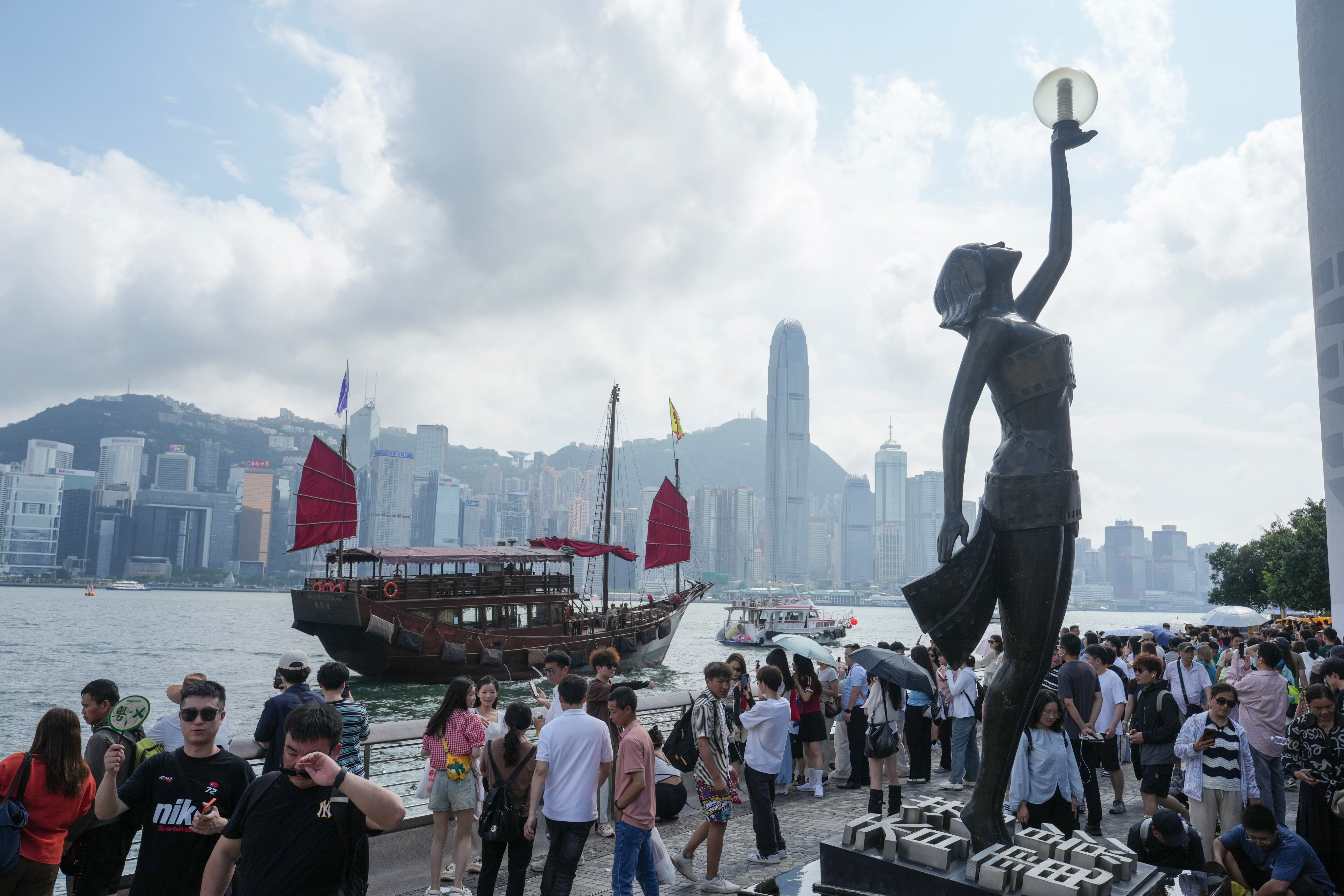 Tourists visit the waterfront of Victoria Harbour in Tsim Sha Tsui, on May 4. Photo: Sam Tsang