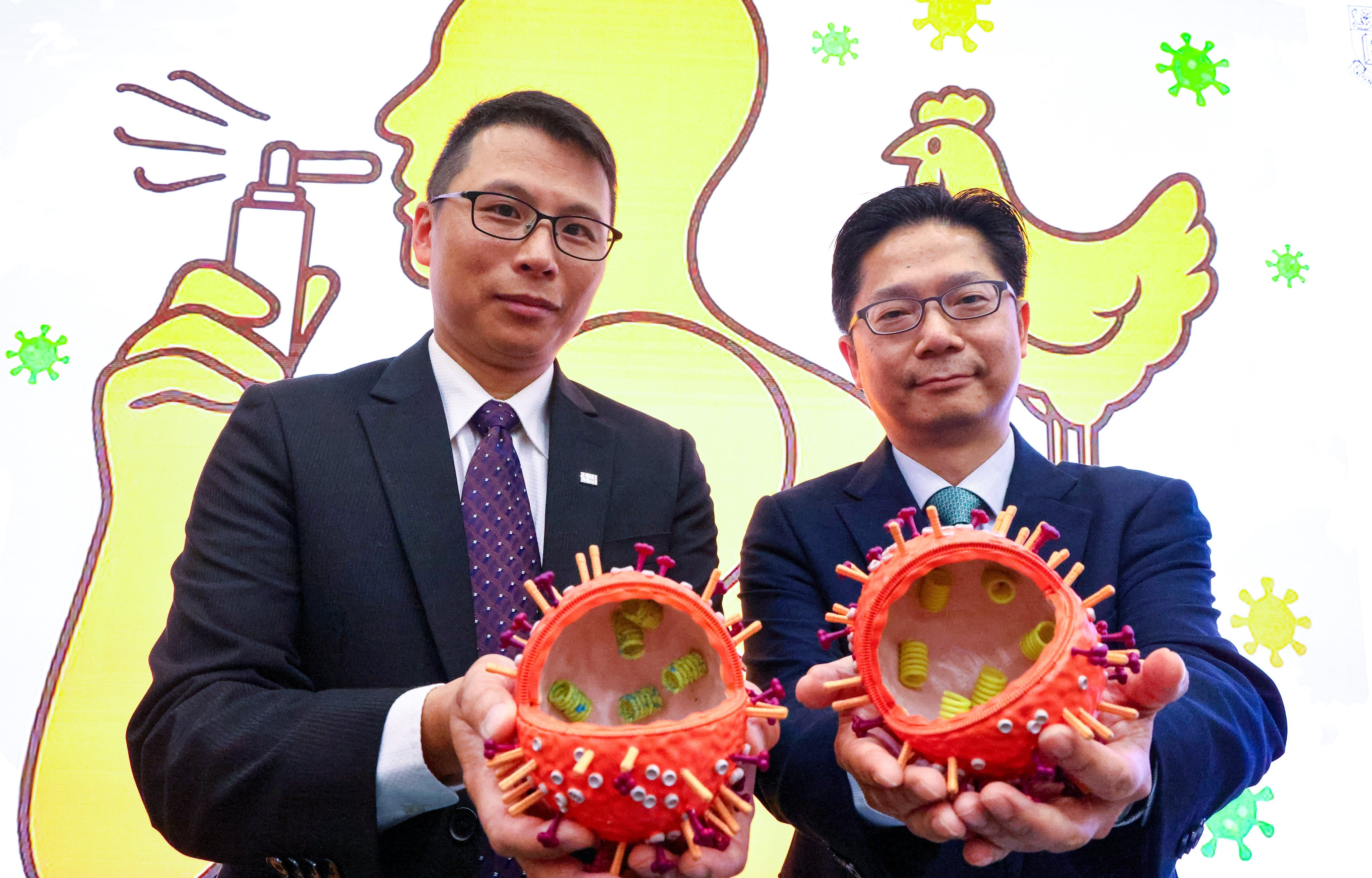 Dr Alex Chin (left) and Professor Leo Poon display virus models as they share a breakthrough in flu development. Photo: Dickson Lee