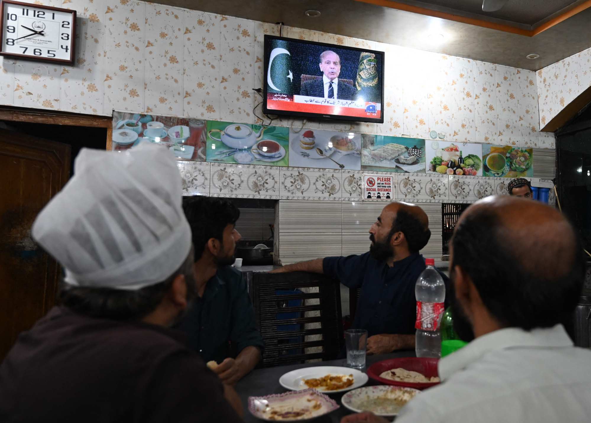 People watch television in a restaurant as Pakistan’s Prime Minister Shehbaz Sharif addresses the nation in Islamabad on Wednesday. Photo: AFP People watch television in a restaurant as Pakistan’s Prime Minister Shehbaz Sharif addresses the nation in Islamabad on Wednesday. Photo: AFP