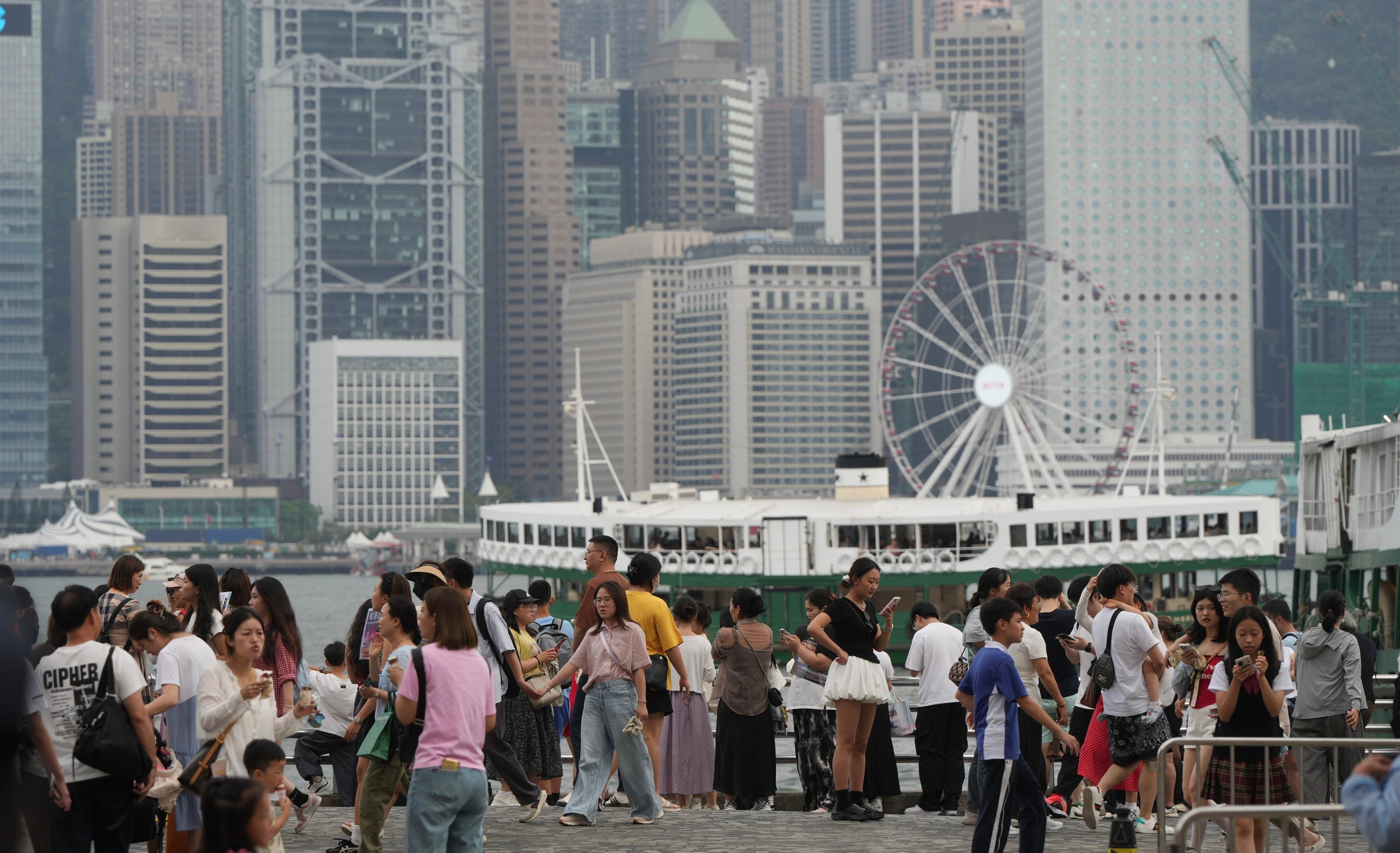 Tourists visit at the waterfront of Victoria Harbour in Tsim Sha Tsui, during the “Golden Week”.  04MAY25 SCMP/ Sam Tsang
