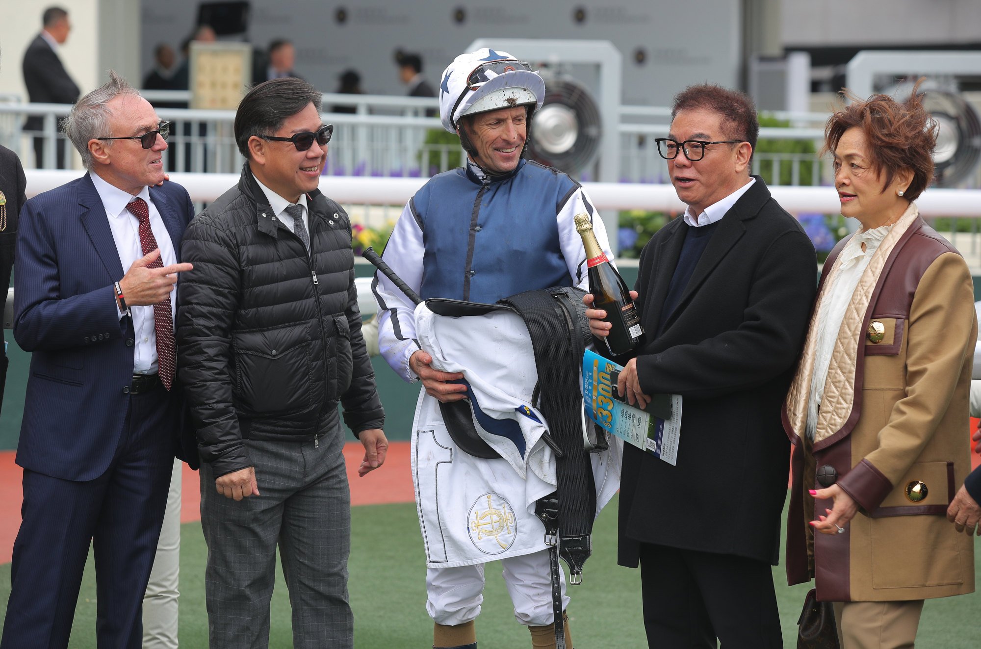 Trainer Dennis Yip (second from left), jockey Hugh Bowman and connections of Fast Network celebrate his latest win.