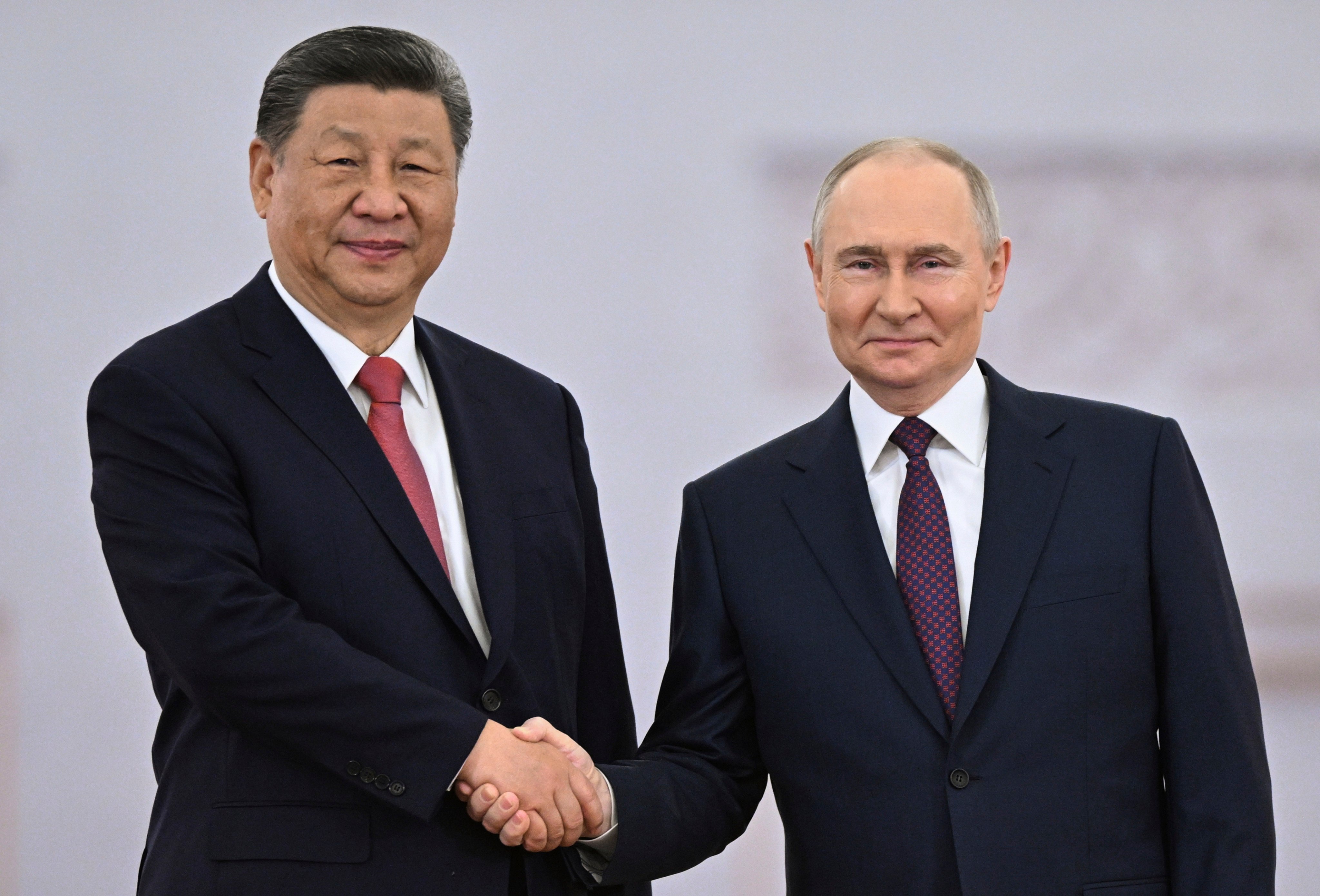 Russian President Vladimir Putin and Chinese leader Xi Jinping shake hands during a welcoming ceremony before their talks at the Kremlin in Moscow on Thursday. Photo: AP
