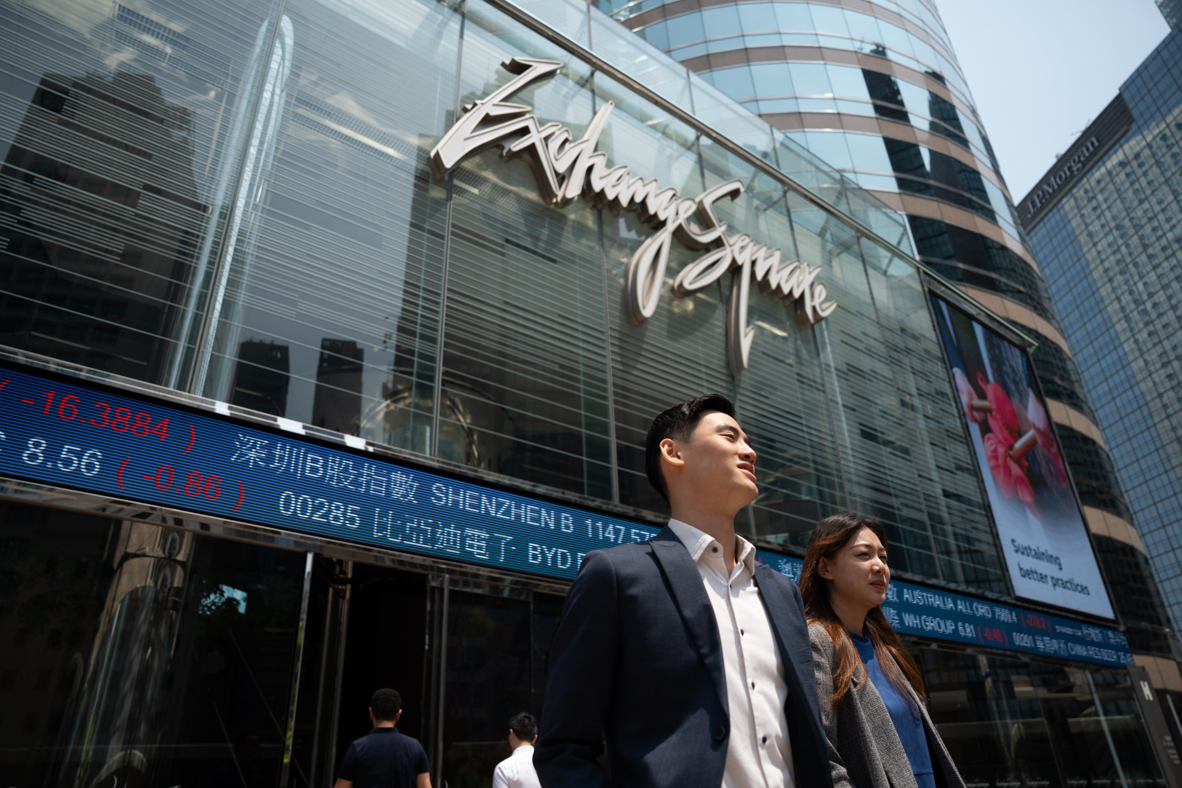 Screens displaying the Hang Seng Index at Exchange Square. Photo: EPA-EFE