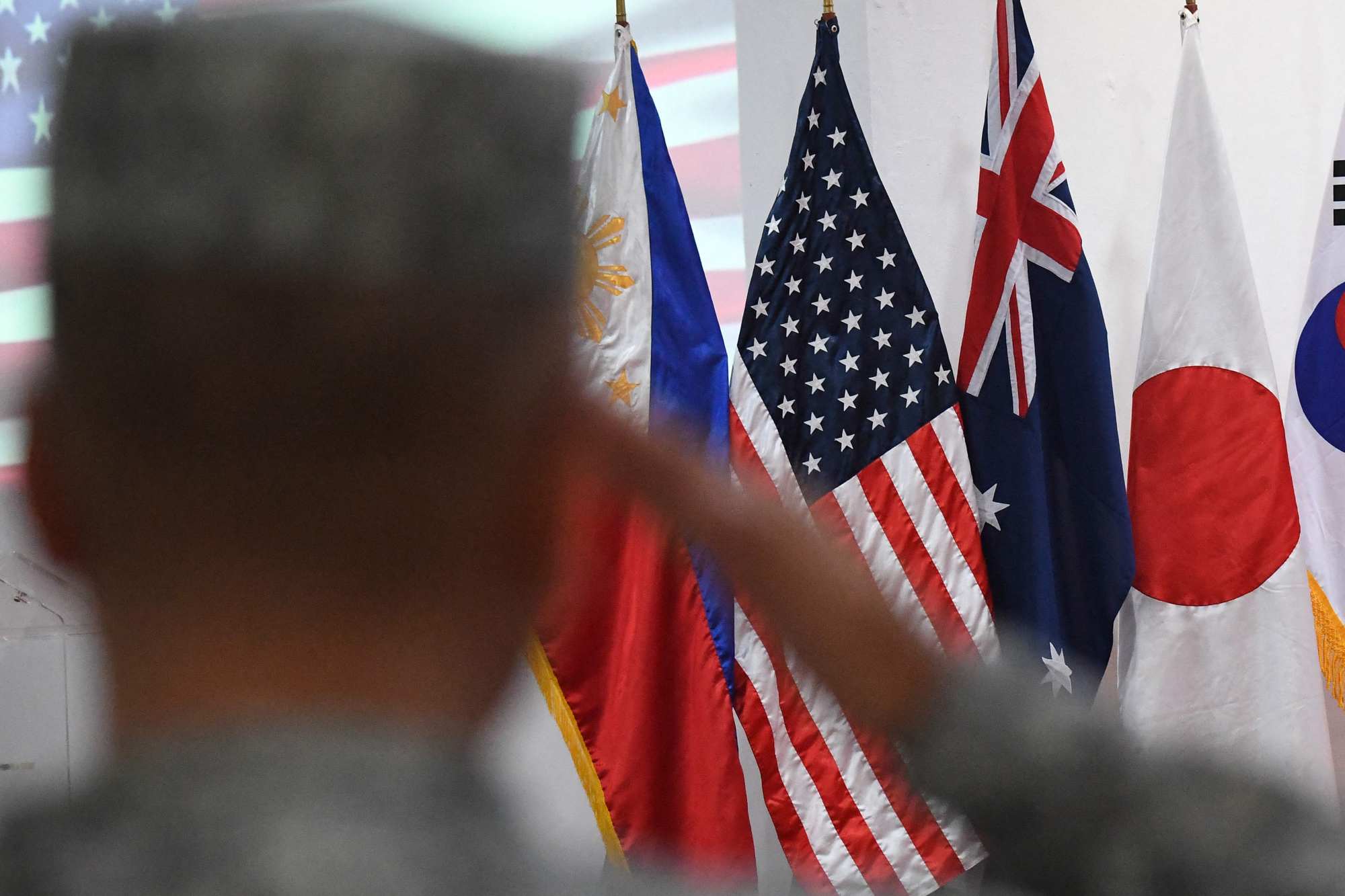 A Philippine Marine salutes in front of US, Philippine, Australia, Japan and South Korea flags during a joint military exercise in Manila in October 2024. Australia is expected to boost economic and security ties with Asia. Photo: AFP A Philippine Marine salutes in front of US, Philippine, Australia, Japan and South Korea flags during a joint military exercise in Manila in October 2024. Australia is expected to boost economic and security ties with Asia. Photo: AFP