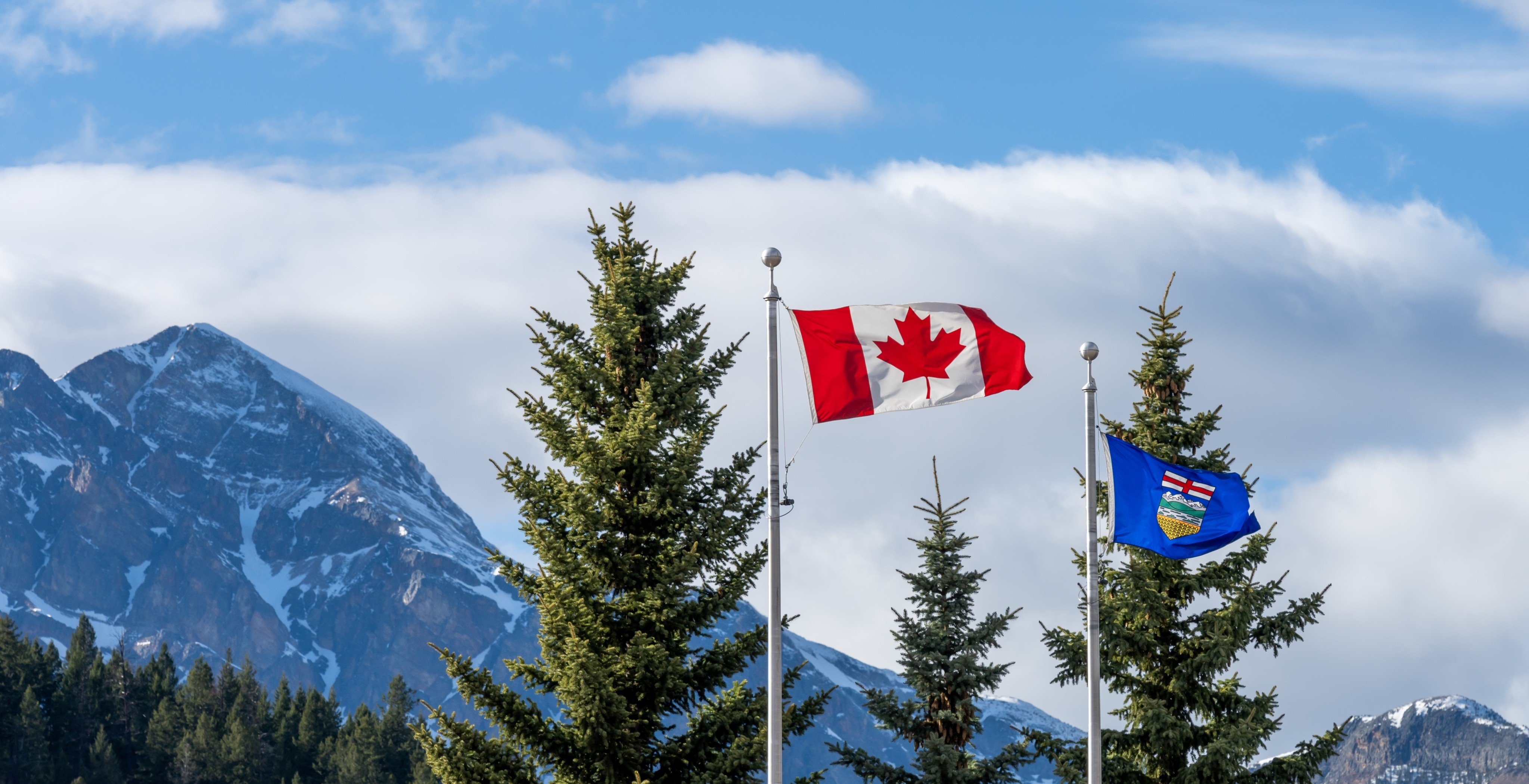 The national flag of Canada and flag of Alberta. Photo: Shutterstock