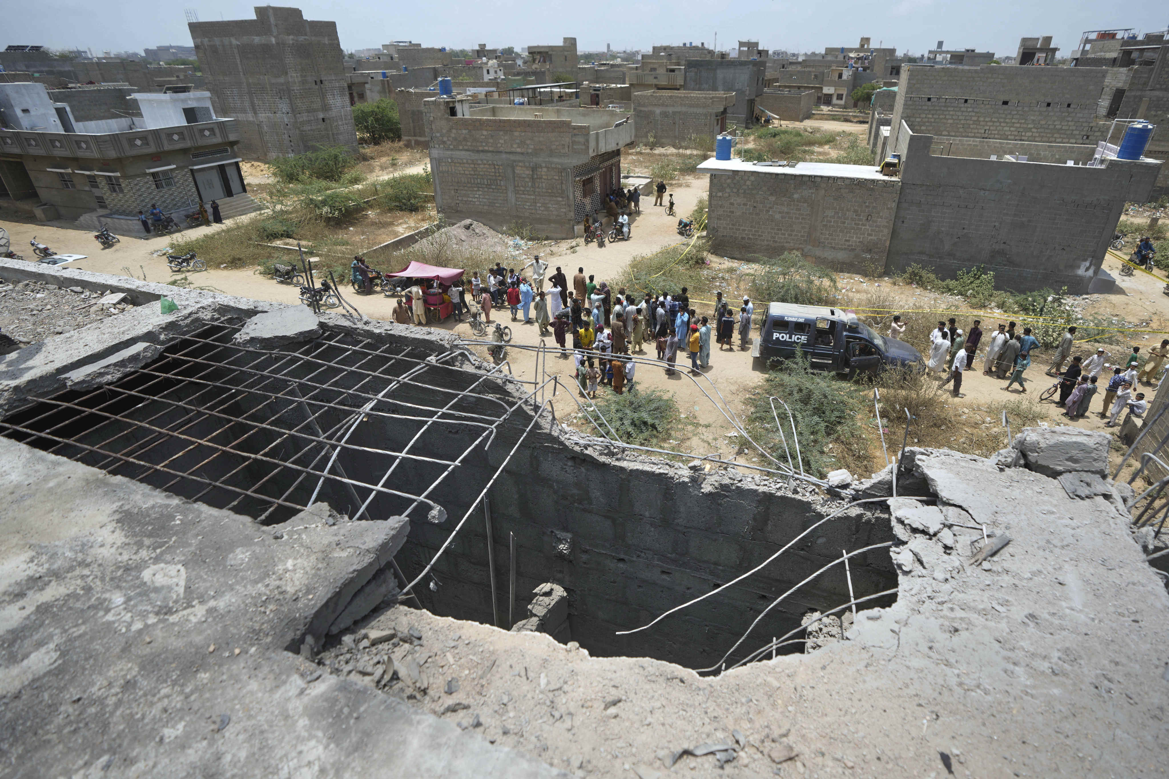 A house bears a gaping hole in its rooftop in Pakistan’s financial capital and largest city Karachi on Thursday, suspected to have been damaged in an Indian drone attack. Photo: AP