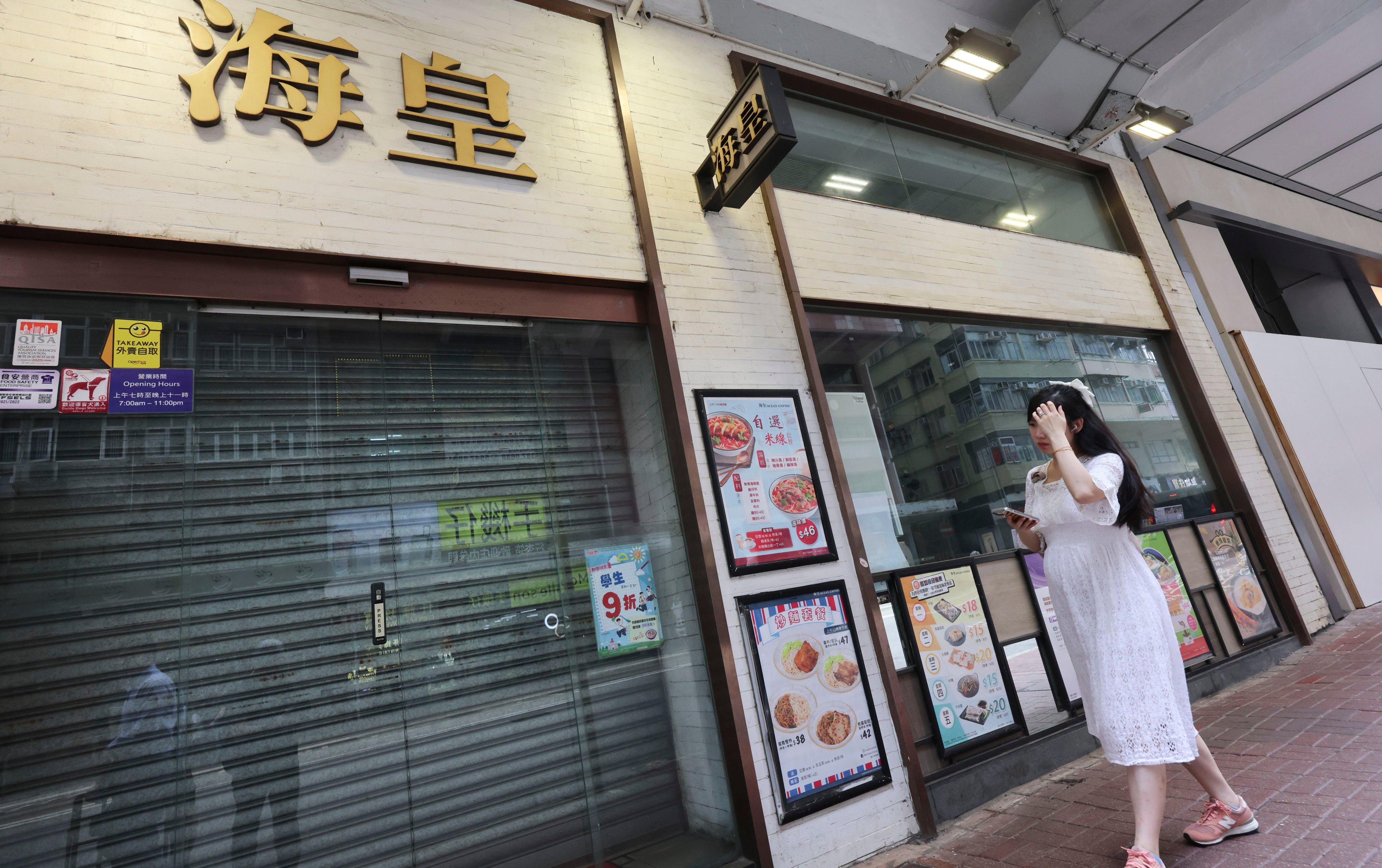 A pedestrian passes a shuttered Ocean Empire congee shop on Johnston Road in Wan Chai on May 8. The restaurant chain, in operation since 1992, suddenly announced the closure of all its locations on May 7. Photo: Jelly Tse
