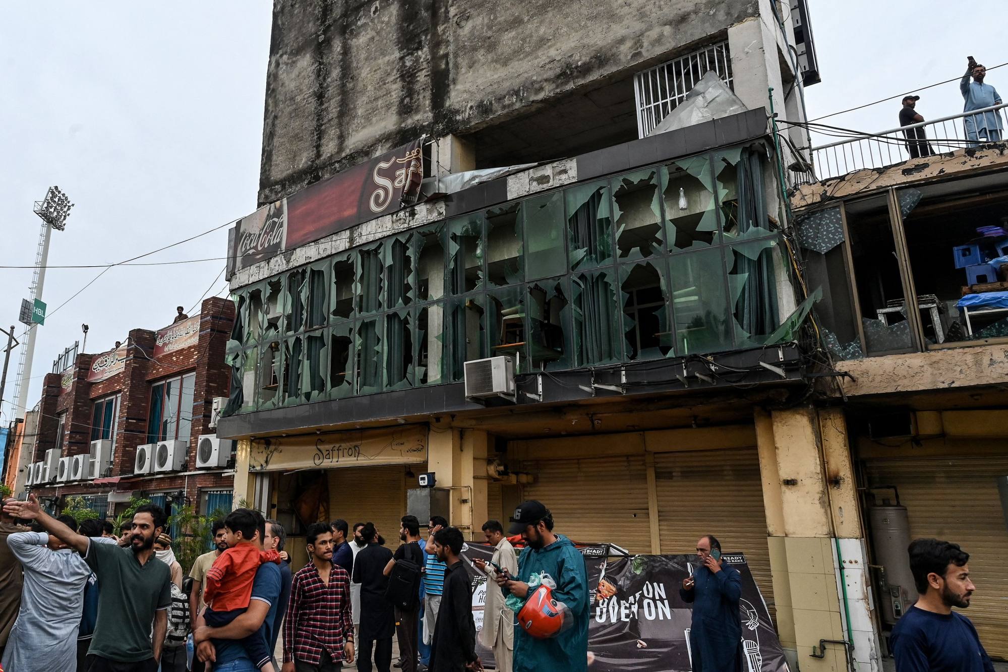 People gather in front of a restaurant outside the Rawalpindi cricket stadium after a drone was shot down in the Pakistan city on May 8. Photo: AFP People gather in front of a restaurant outside the Rawalpindi cricket stadium after a drone was shot down in the Pakistan city on May 8. Photo: AFP