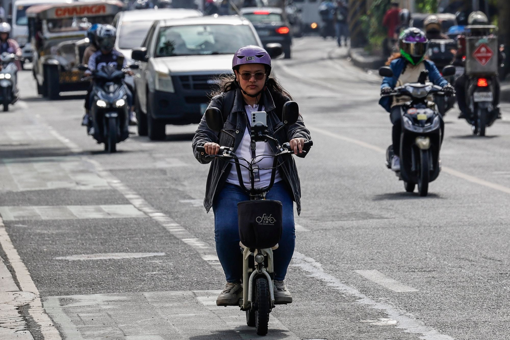 A motorist rides an electric scooter in Makati City, Metro Manila, on Thursday. Urban planner Dan Bayona says a robust transport infrastructure can help reduce road crashes and fatalities. Photo: EPA-EFE A motorist rides an electric scooter in Makati City, Metro Manila, on Thursday. Urban planner Dan Bayona says a robust transport infrastructure can help reduce road crashes and fatalities. Photo: EPA-EFE