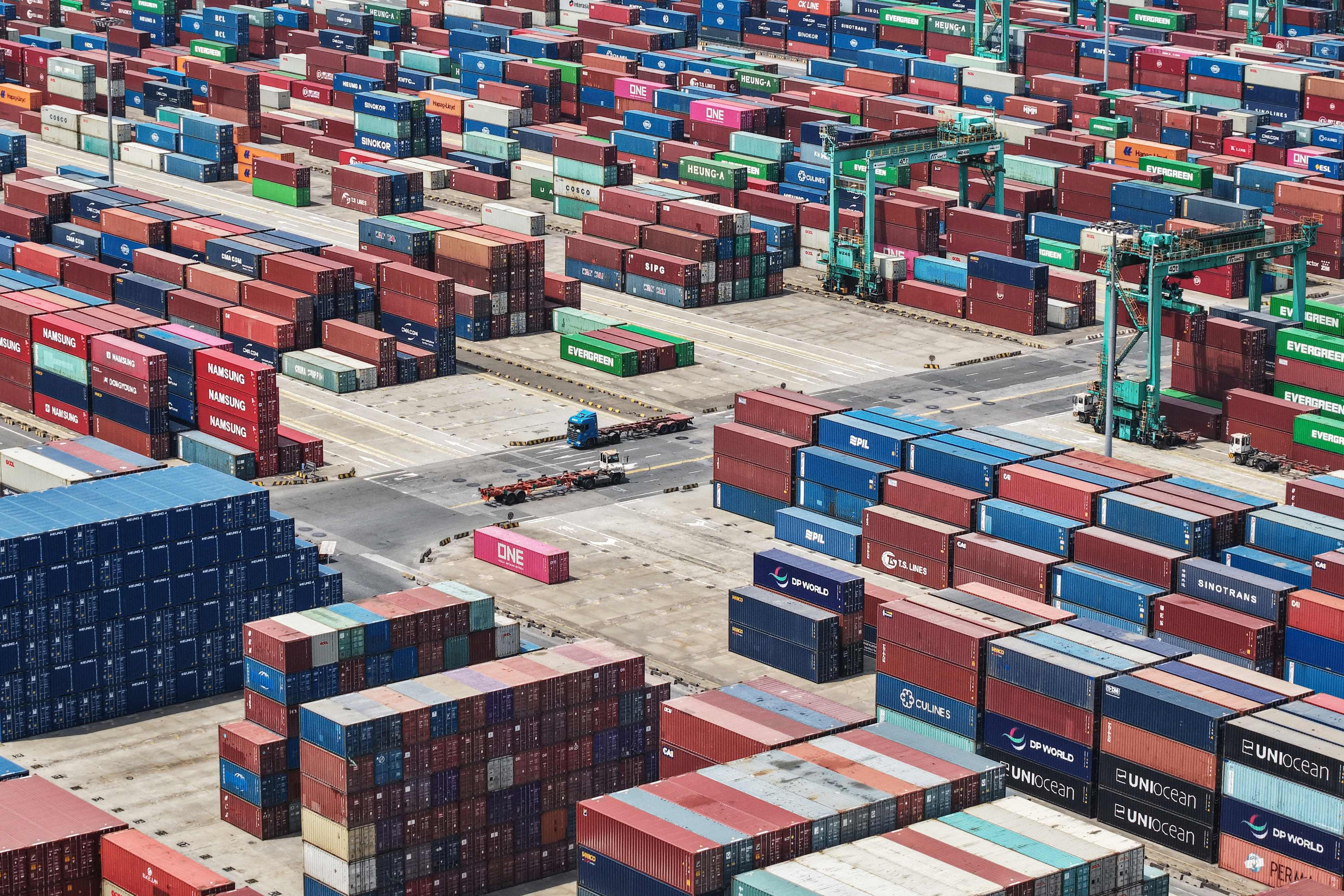 Shipping containers are stacked at a port in Shanghai on Friday. Photo: AFP