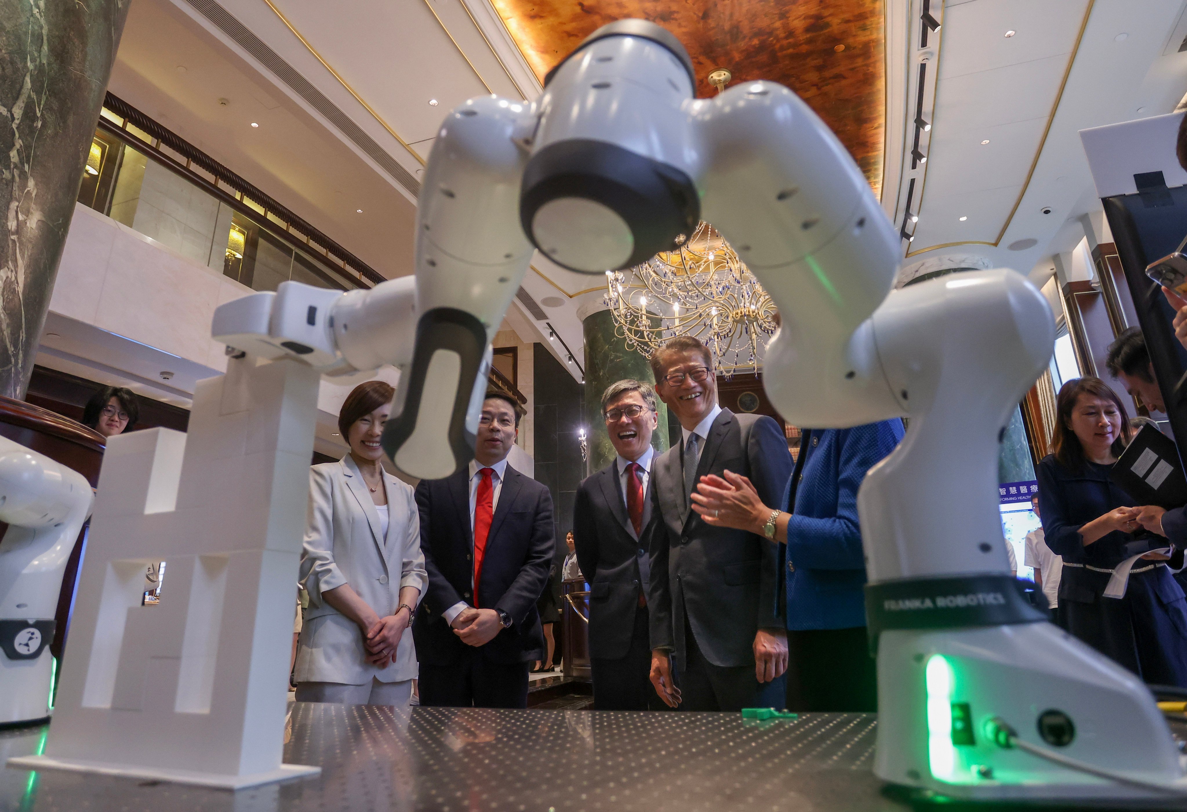 Robot technology is displayed during the Von Neumann Institute’s inauguration ceremony attended by Financial Secretary Paul Chan (third from left). Photo: SCMP