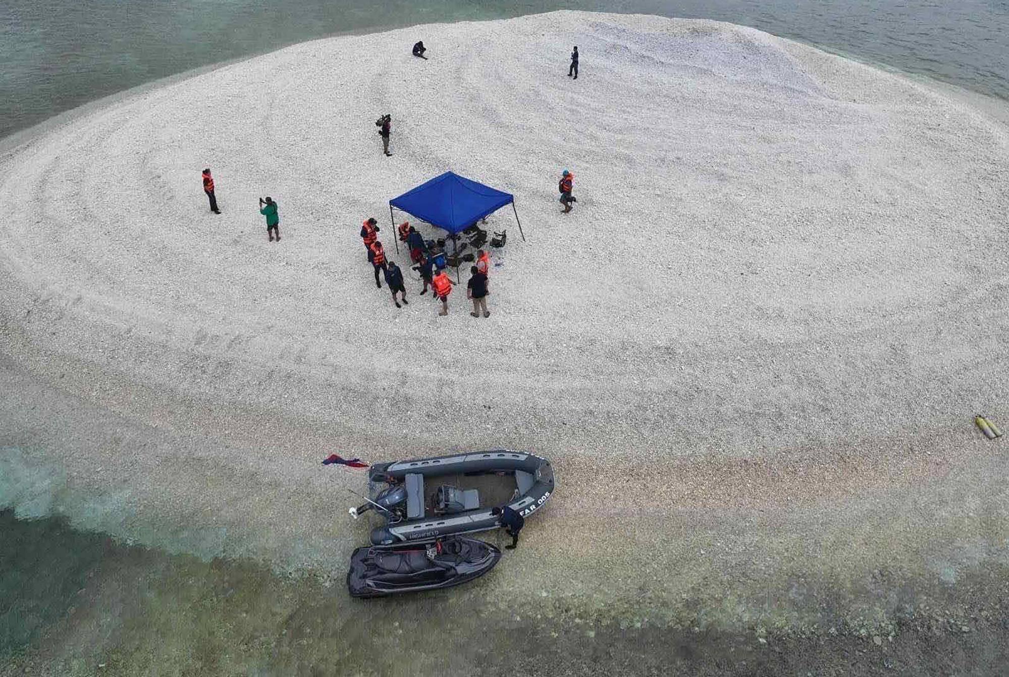 Scientists inspect Sandy Cay reef, near the Philippine-held Thitu Island, in disputed waters of the South China Sea. Photo: AFP Scientists inspect Sandy Cay reef, near the Philippine-held Thitu Island, in disputed waters of the South China Sea. Photo: AFP