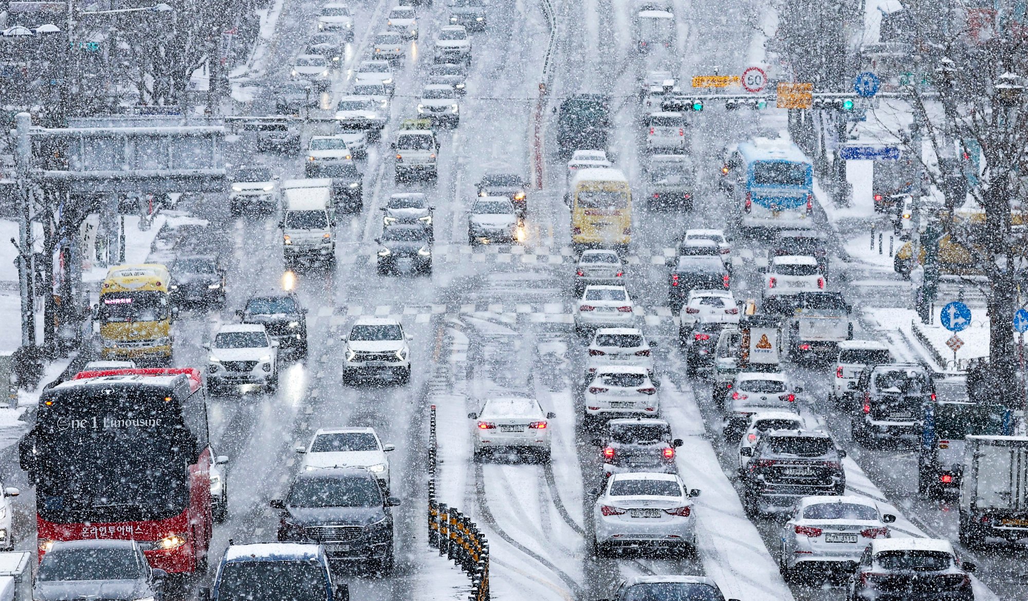 Vehicles drive in the snow in Suwon. A man killed his wife in the South Korean city by striking her with a blunt object in their home. Photo: Yonhap Vehicles drive in the snow in Suwon. A man killed his wife in the South Korean city by striking her with a blunt object in their home. Photo: Yonhap