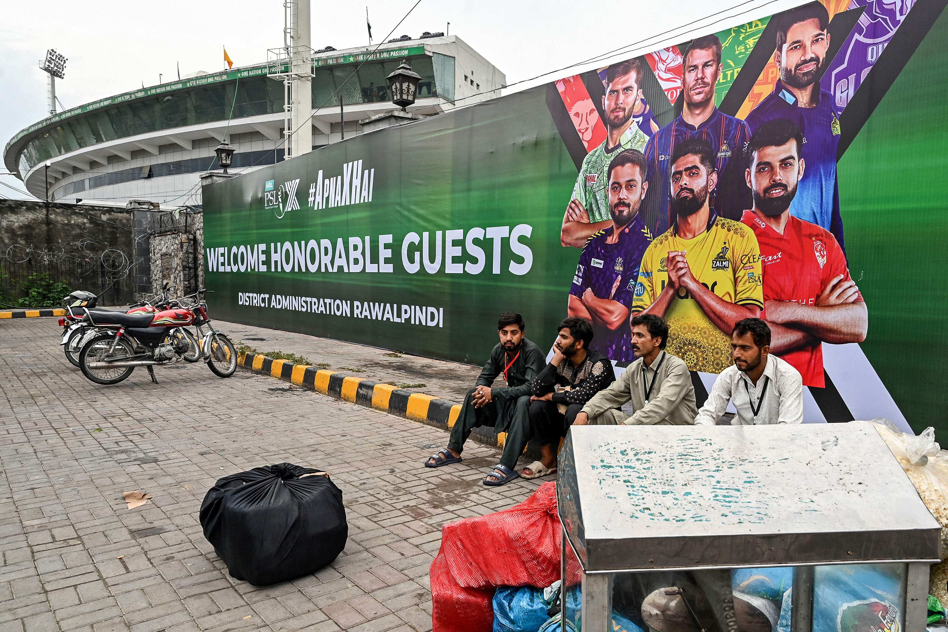 Vendors pack their belongings as they leave Rawalpindi Cricket Stadium after the postponement of the Pakistan Super League (PSL) match following the alleged shooting of a drone outside the stadium  on May 8. Photo: AFP