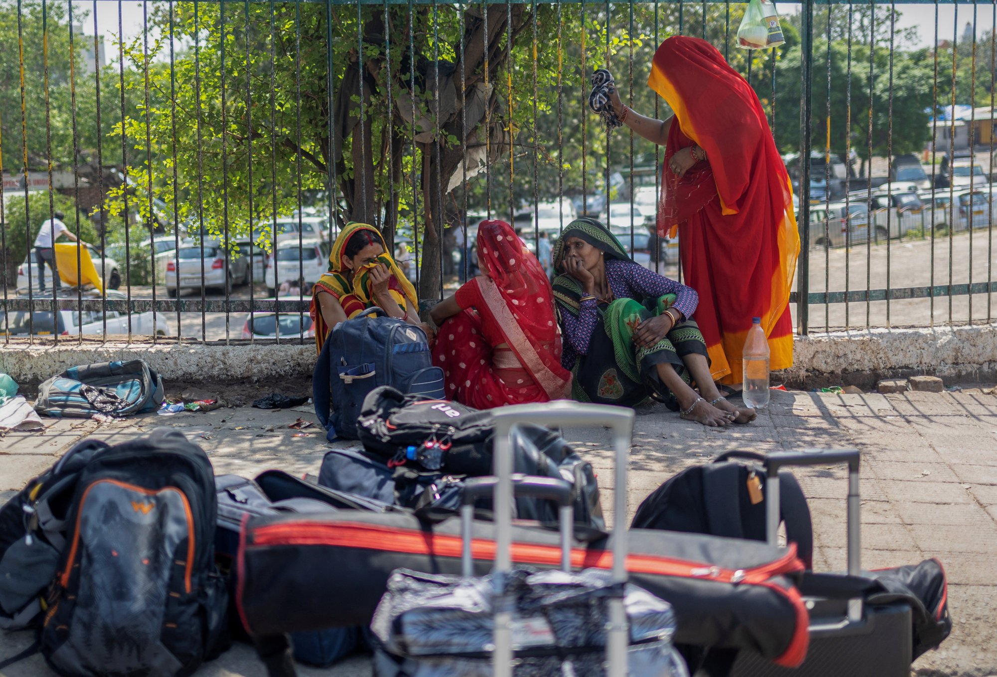 A family of a migrant worker sits outside a railway station before boarding a train at a railway station in Jammu on Saturday. Photo: Reuters A family of a migrant worker sits outside a railway station before boarding a train at a railway station in Jammu on Saturday. Photo: Reuters