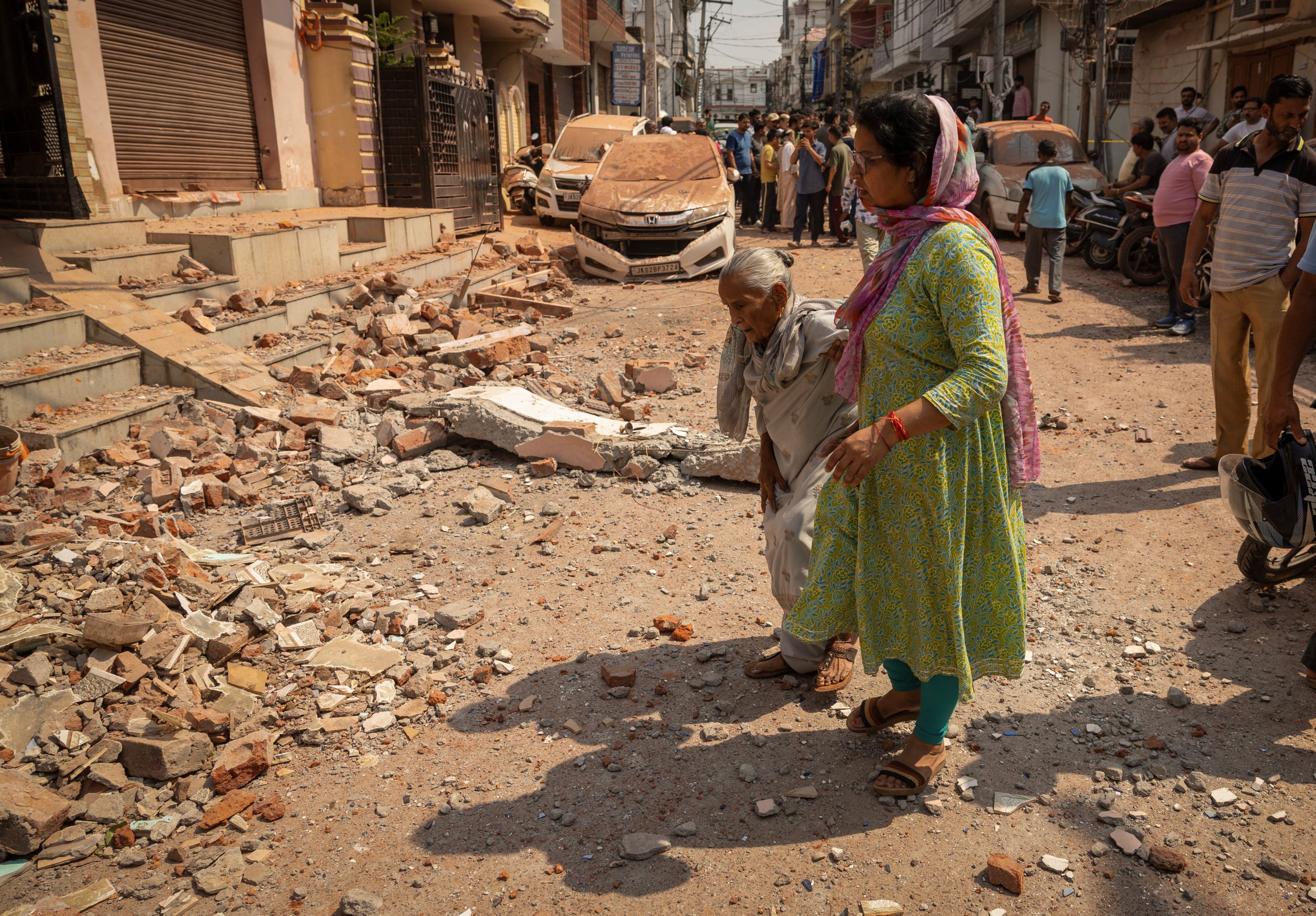 Women walk towards their damaged home following Pakistan’s military operation against India, in Rehari, Jammu, on Saturday. Photo: Reuters