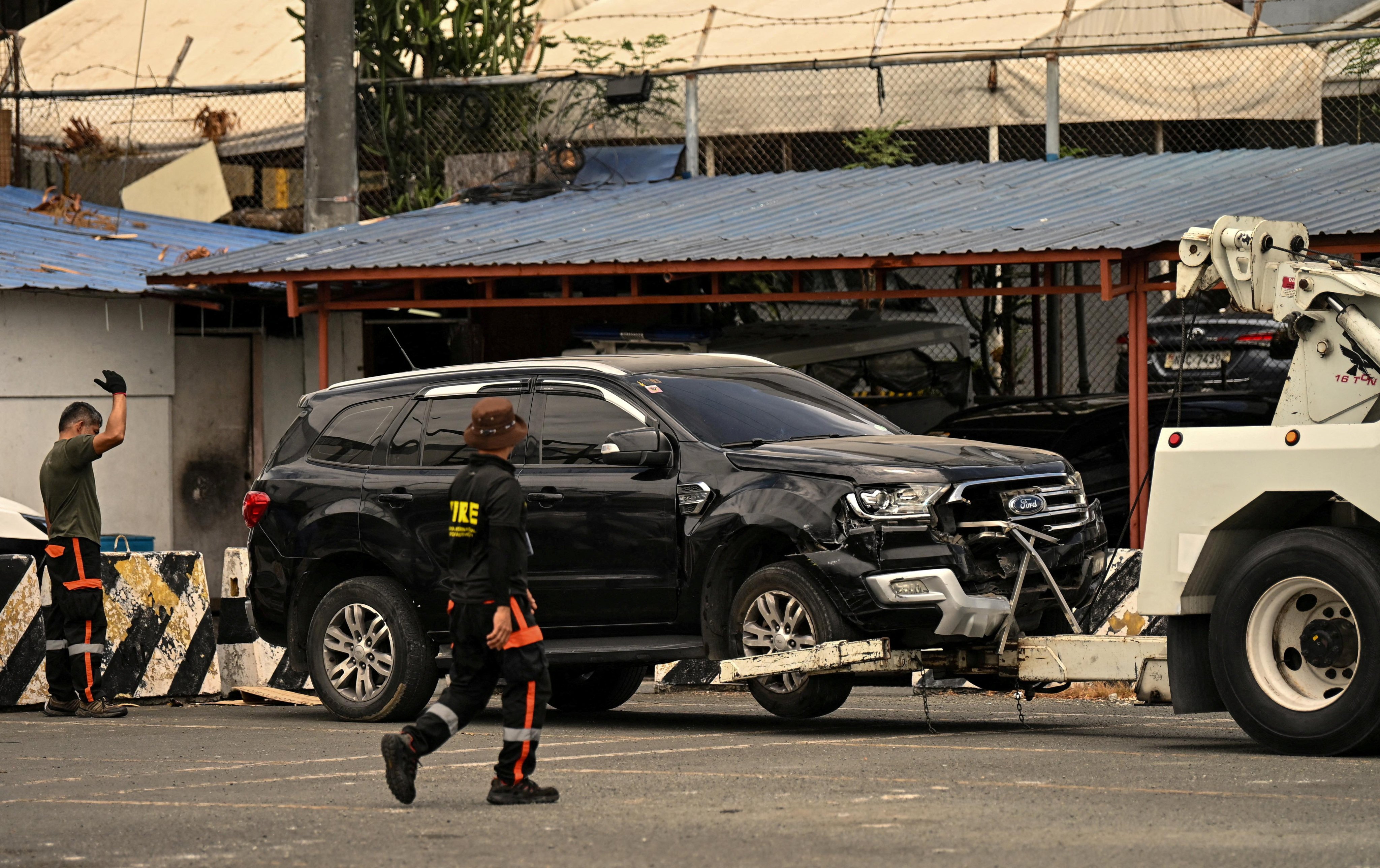 Workers tow a vehicle that crashed into the entrance of Ninoy Aquino International Airport Terminal 1 in Manila on May 4, killing two and injuring several others. Photo: Reuters