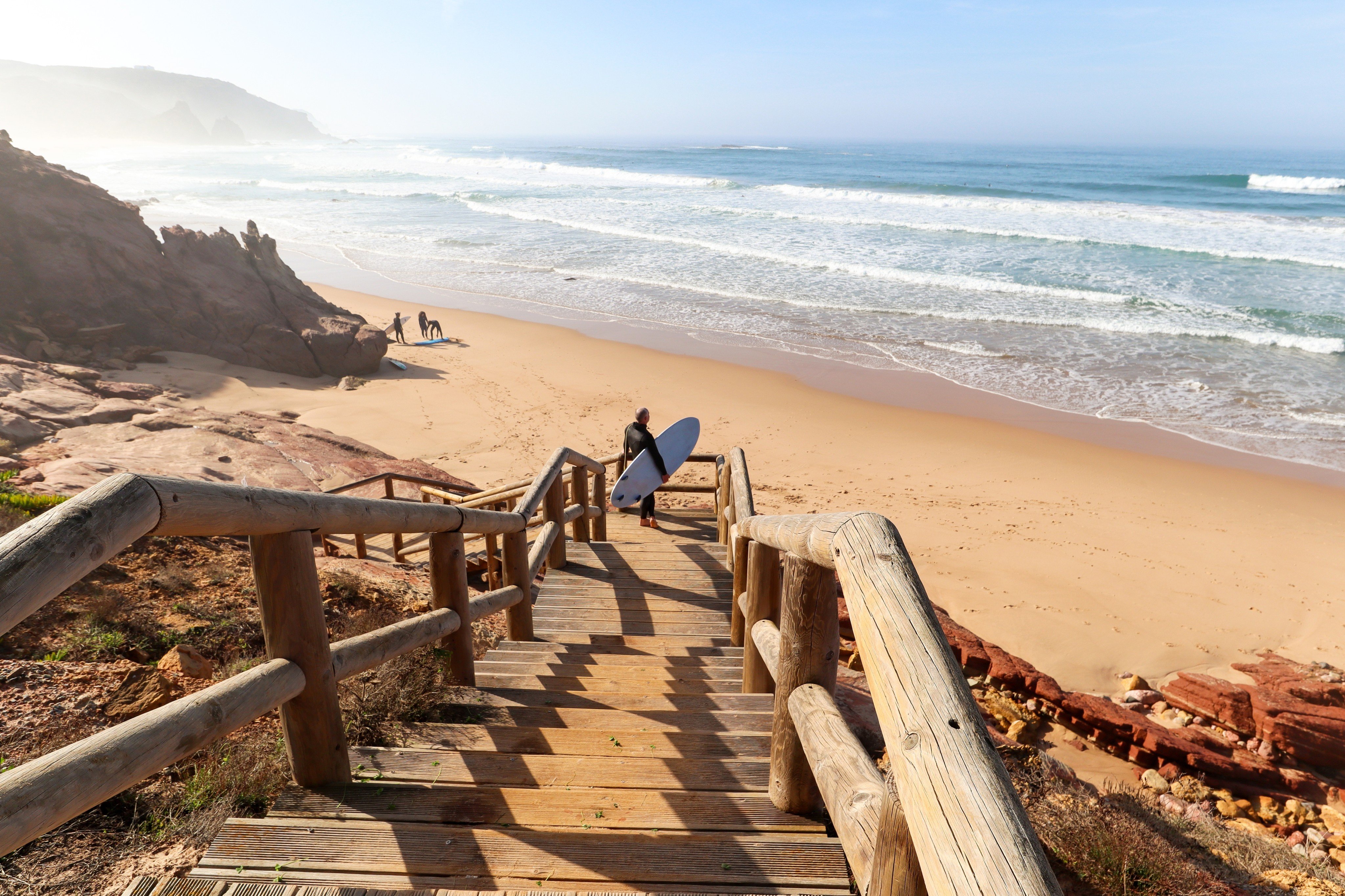 A surfer looks out over Praia do Amado, a beach and surf spot near Sagres and Lagos in Portugal’s southern Algarve region. Photo: Shutterstock