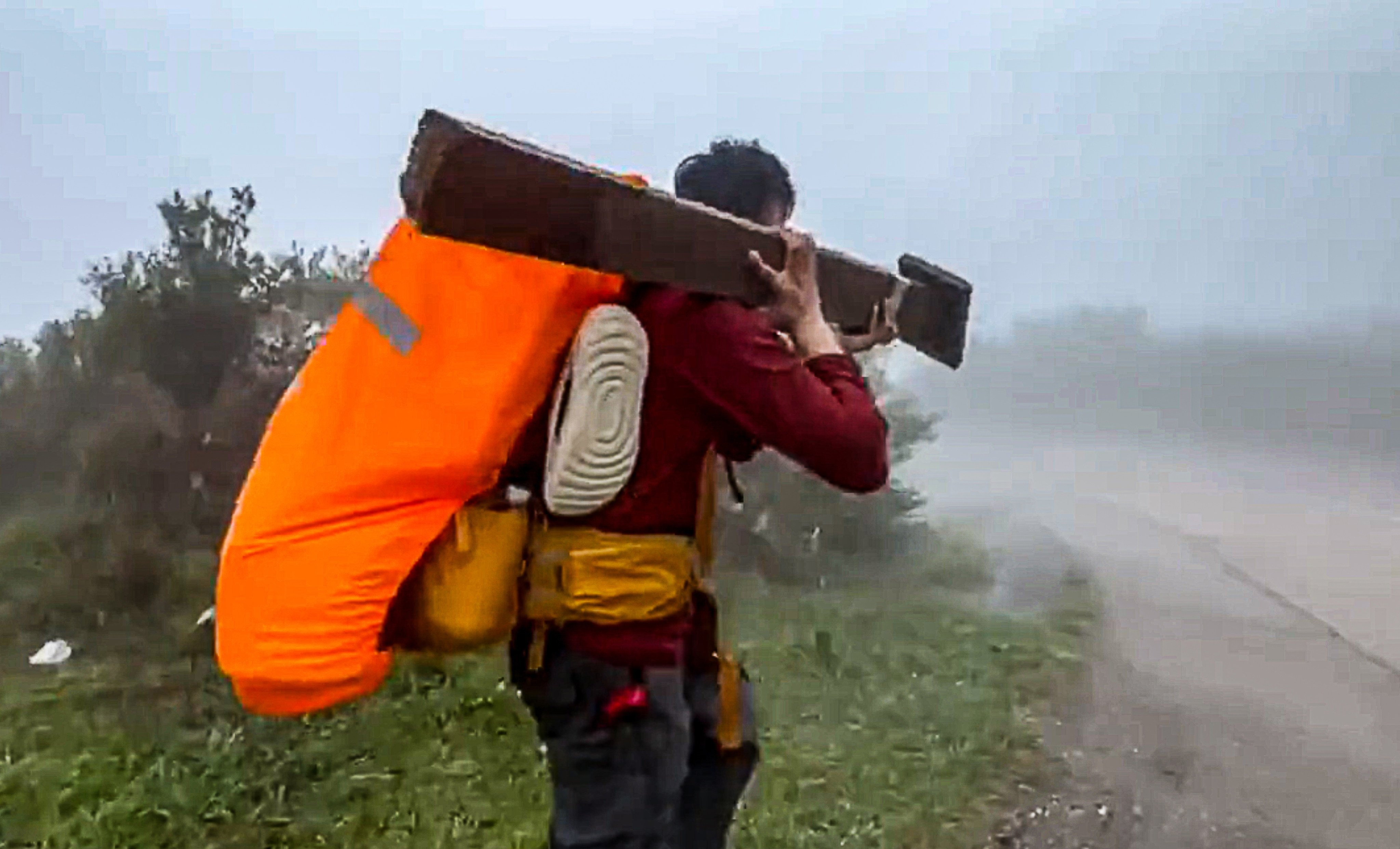 A screengrab of the video shows the man carrying off the trail marker. Photo: Handout