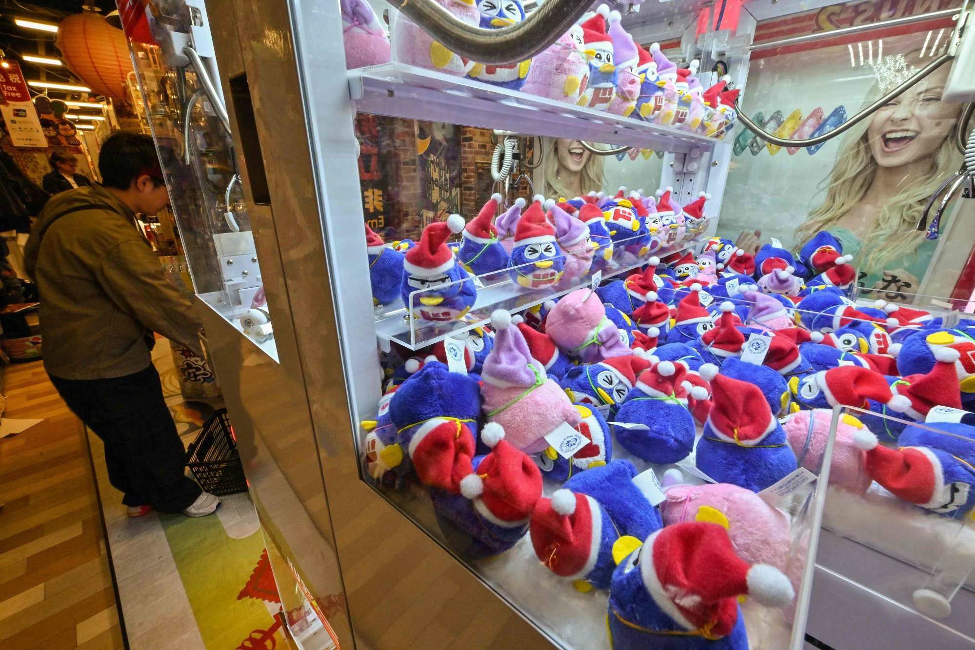A machine sells little versions of Don Quijote’s mascot Donpen at a Tokyo store. Photo: AFP A machine sells little versions of Don Quijote’s mascot Donpen at a Tokyo store. Photo: AFP
