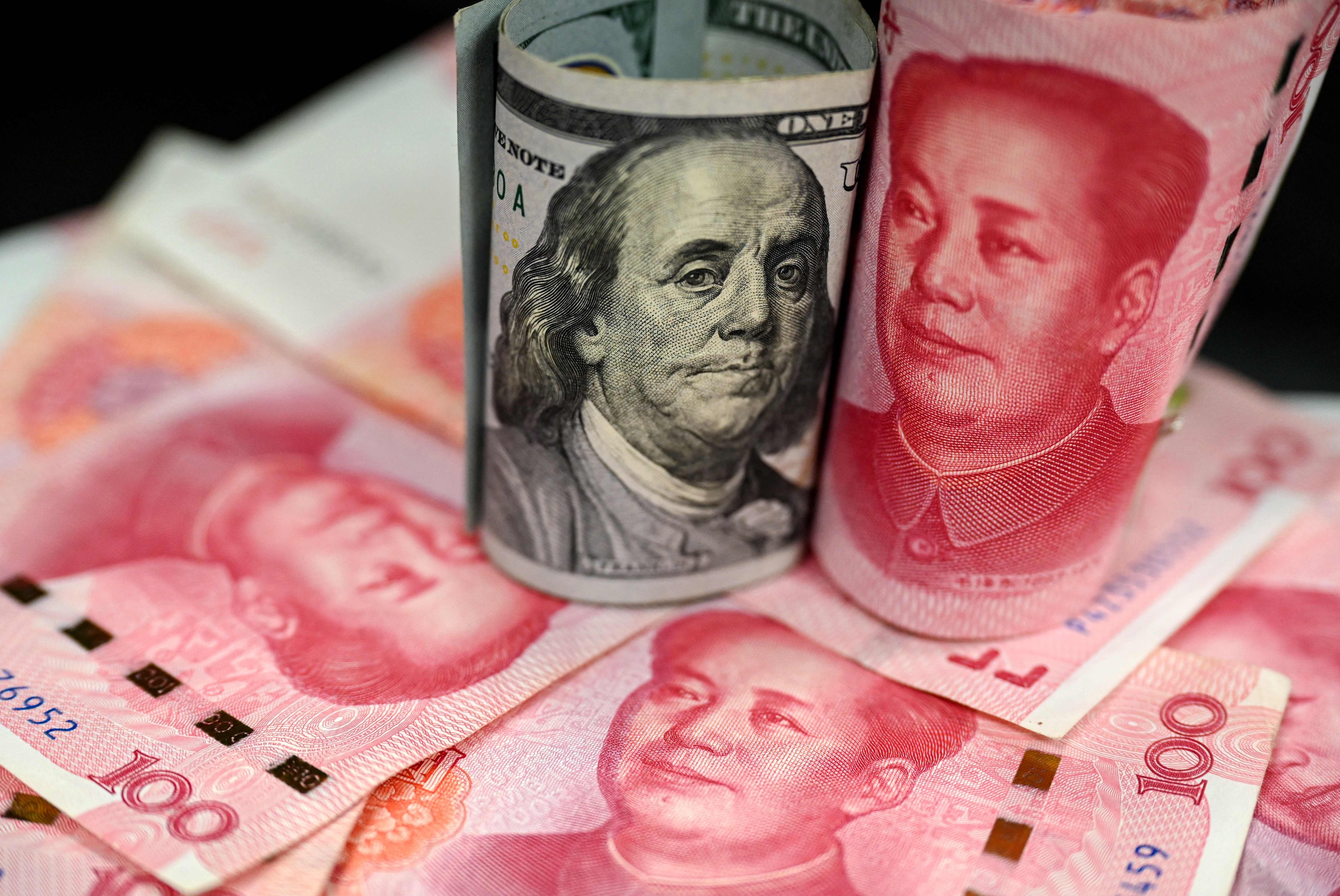 This photo illustration shows Chinese yuan notes and US dollar notes, in Beijing on April 8, 2025. Photo; AFP