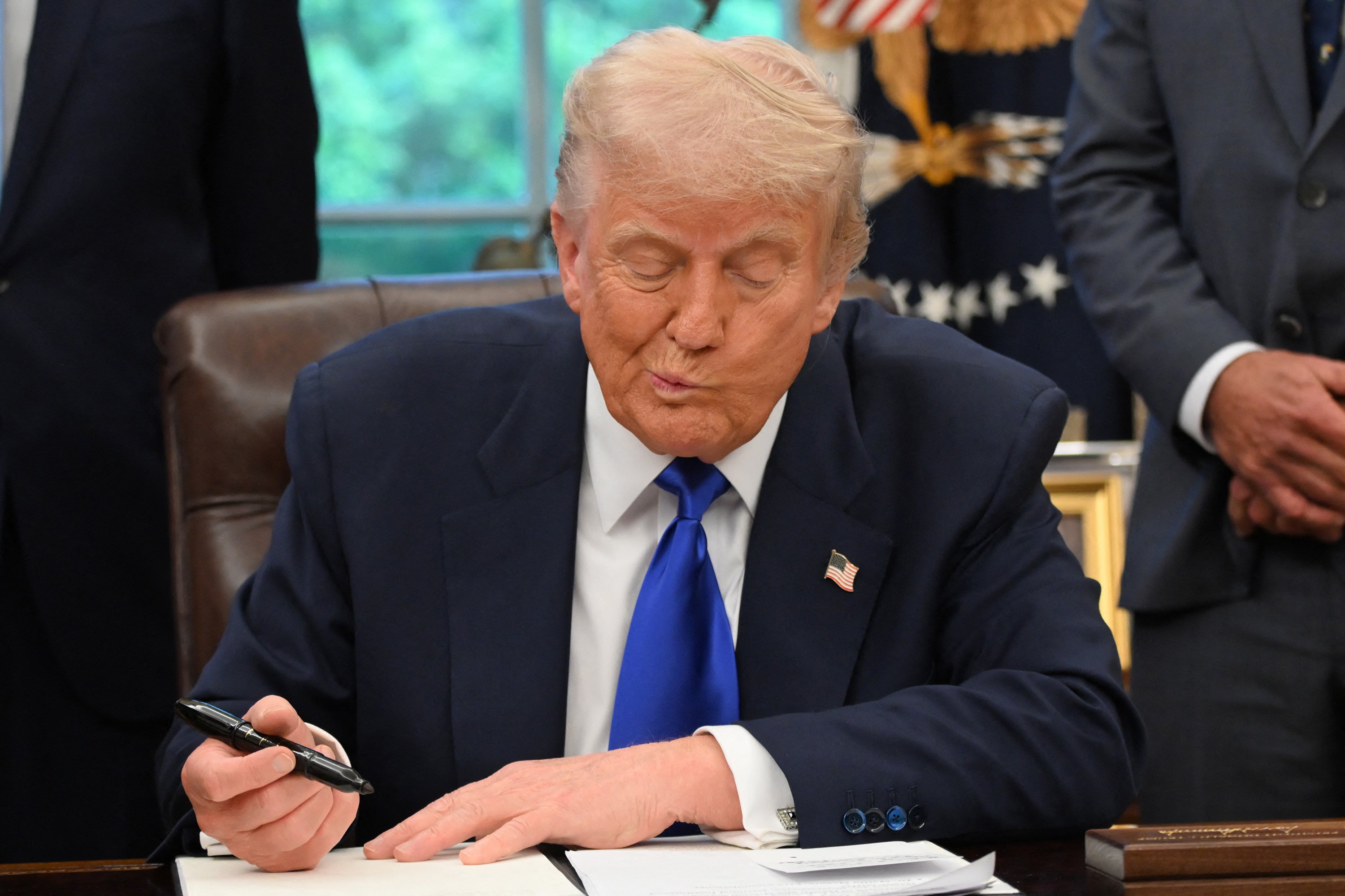 US President Donald Trump signing executive orders at the White House. Photo: AFP