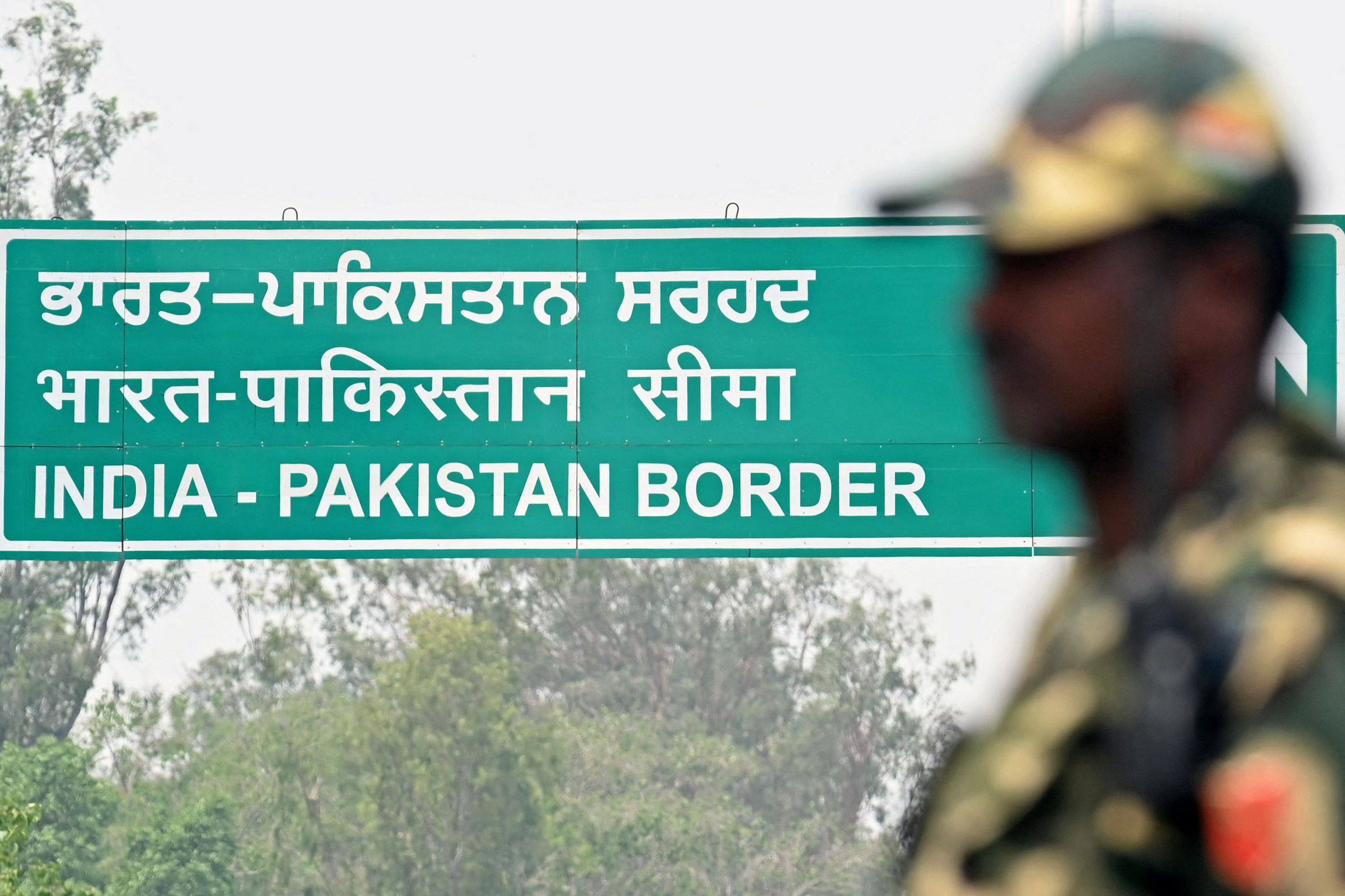 An Indian border guard stands guard near the India-Pakistan border. Photo: AFP