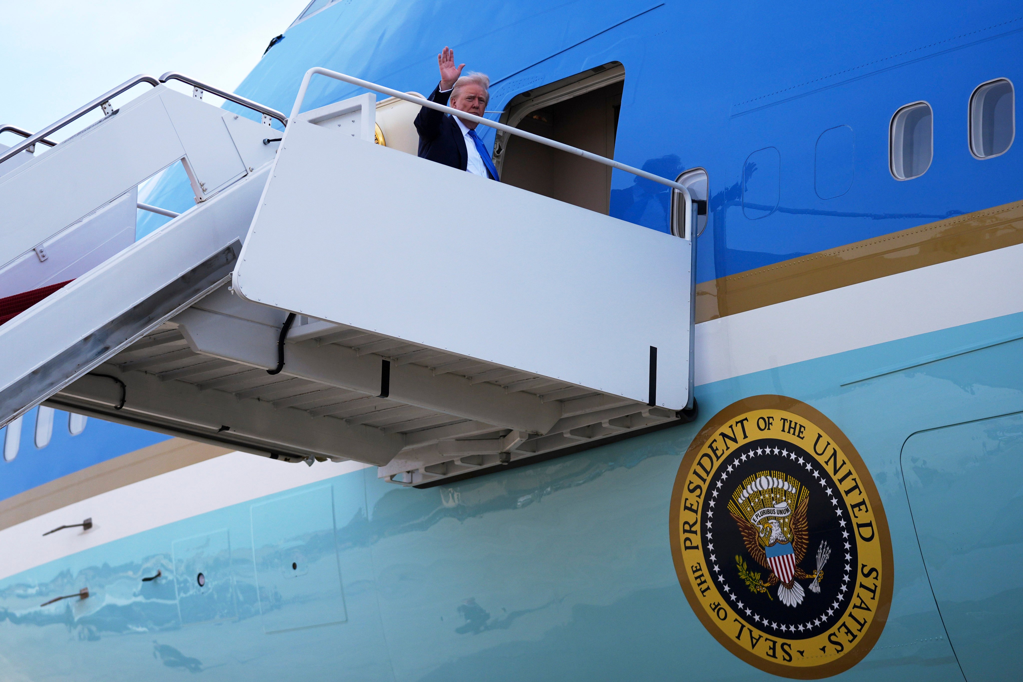 President Donald Trump boards Air Force One for a trip. Photo: AP