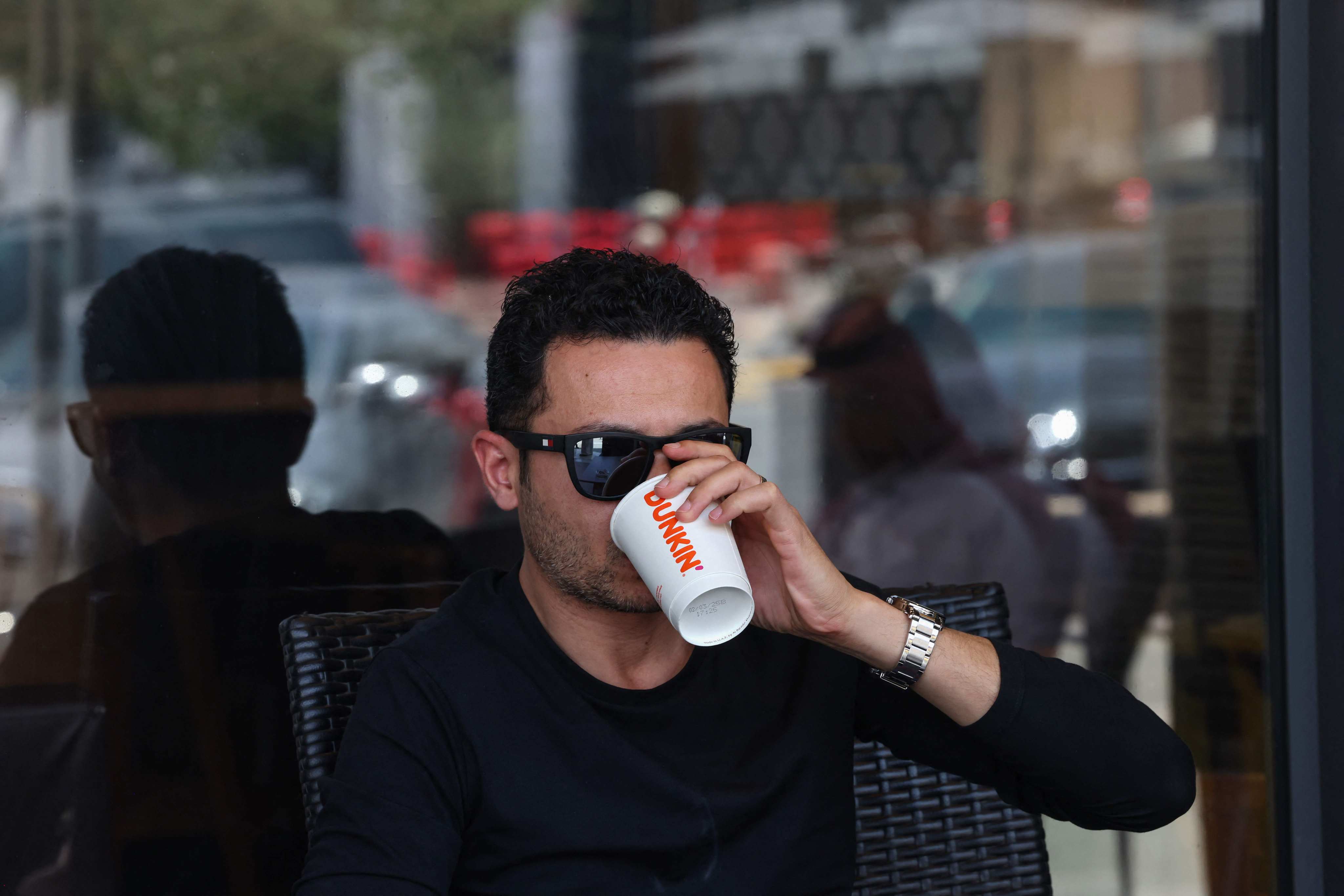 A customer at a Dunkin’ Donuts coffee shop in Riyadh. Photo: AFP