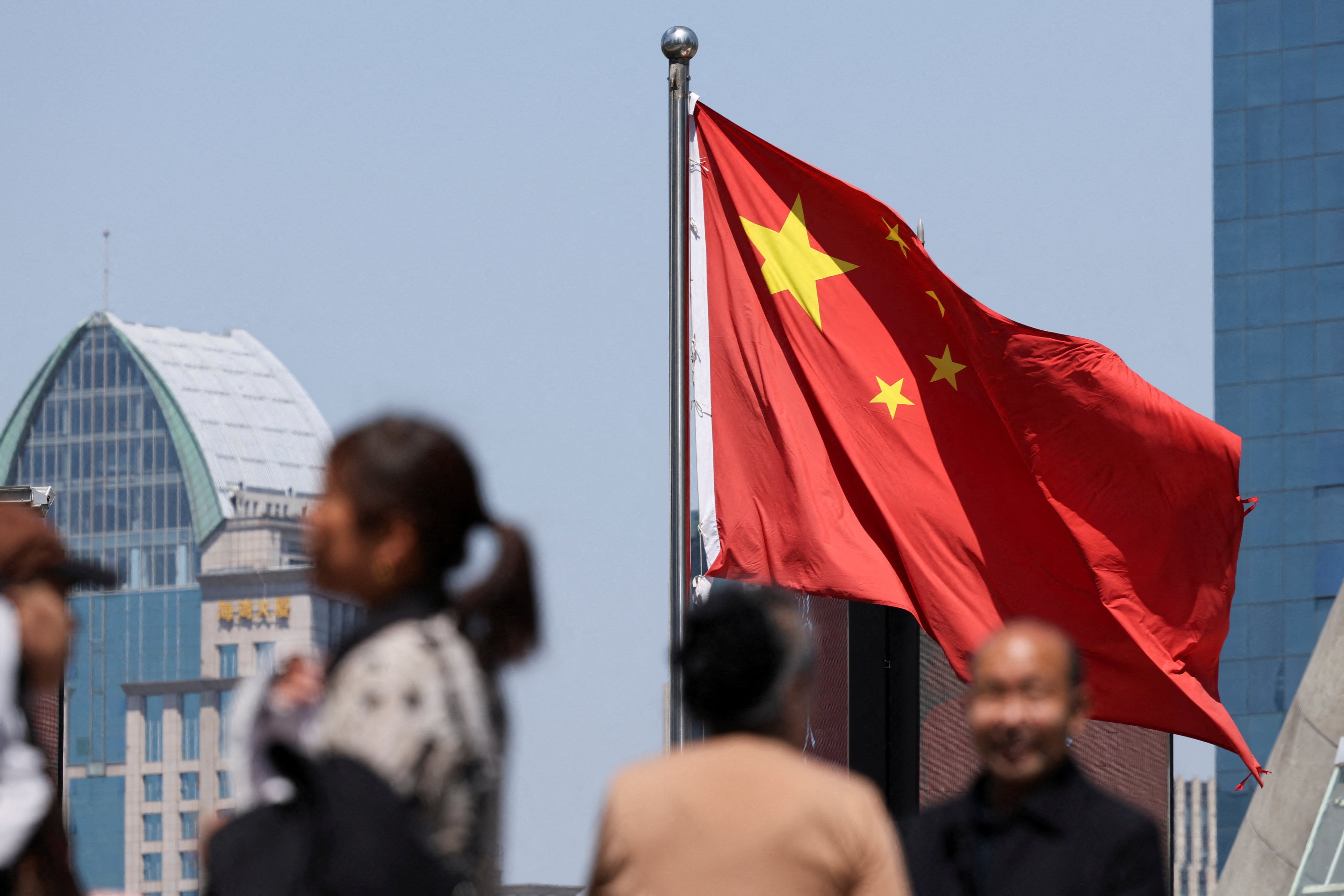 People pass through Shanghai’s financial district. Photo: Reuters