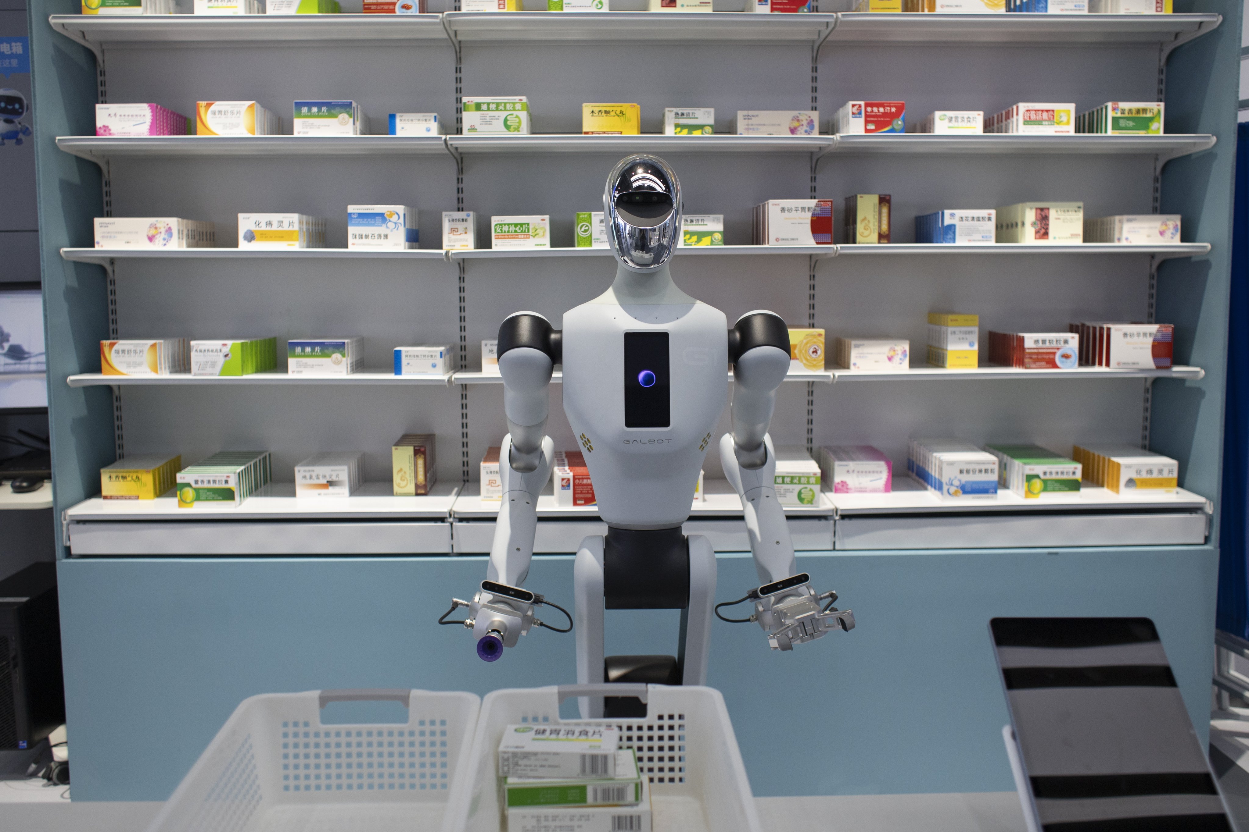 A humanoid robot is shown delivering drugs at a mock pharmacy in Beijing in April 2025. Photo: EPA-EFE