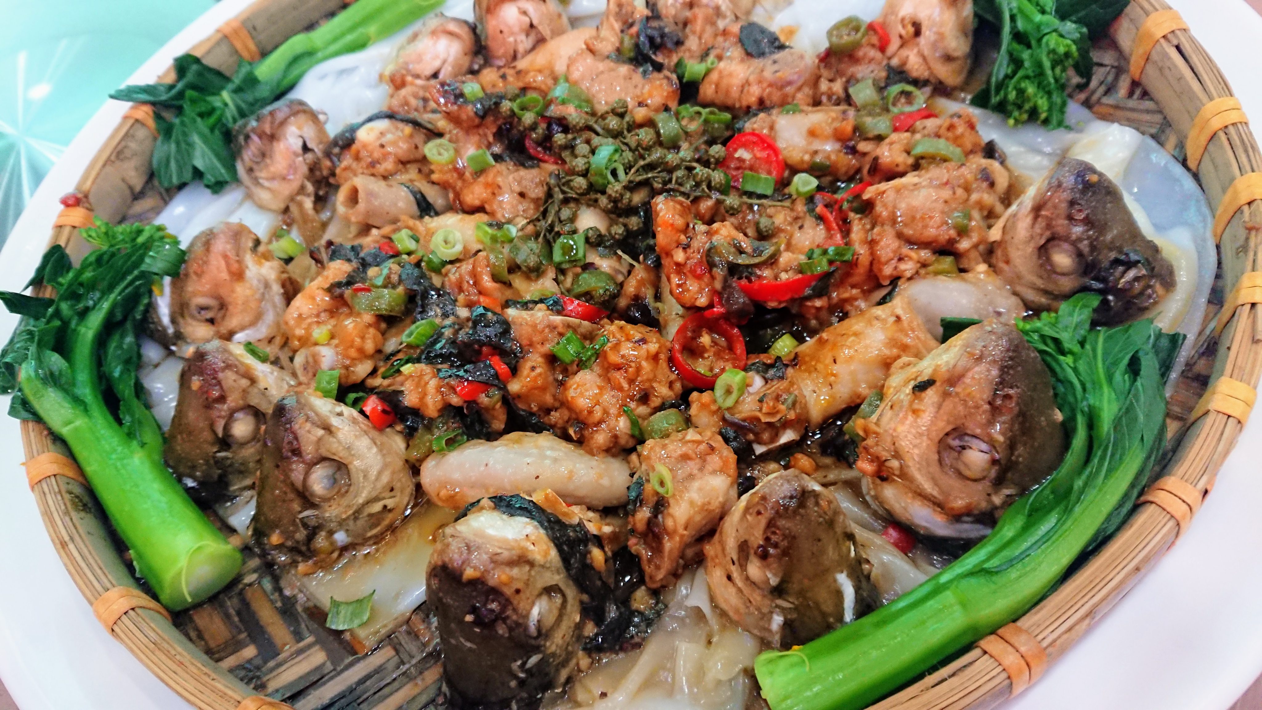 Steamed spare ribs, pork intestines and dace fish heads served on a bed of Chencun flat noodles at Big Happiness Canteen in Beijiao, a town in Shunde, in China’s Guangdong province.